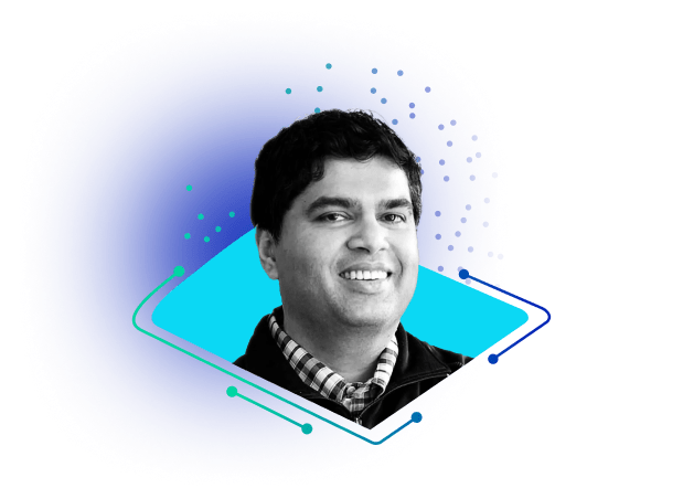 Black-and-white headshot of a smiling man over a bright blue abstract background with turquoise geometric accents
