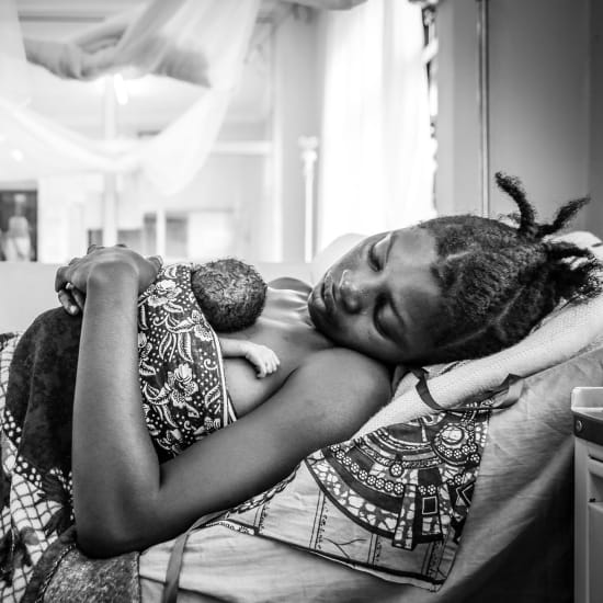 Premature baby Robert was born in a refugee camp in Tanzania. Here he takes a moment to rest in his mother’s arms.