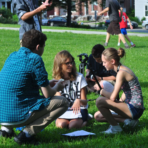 Film students collaborating on set