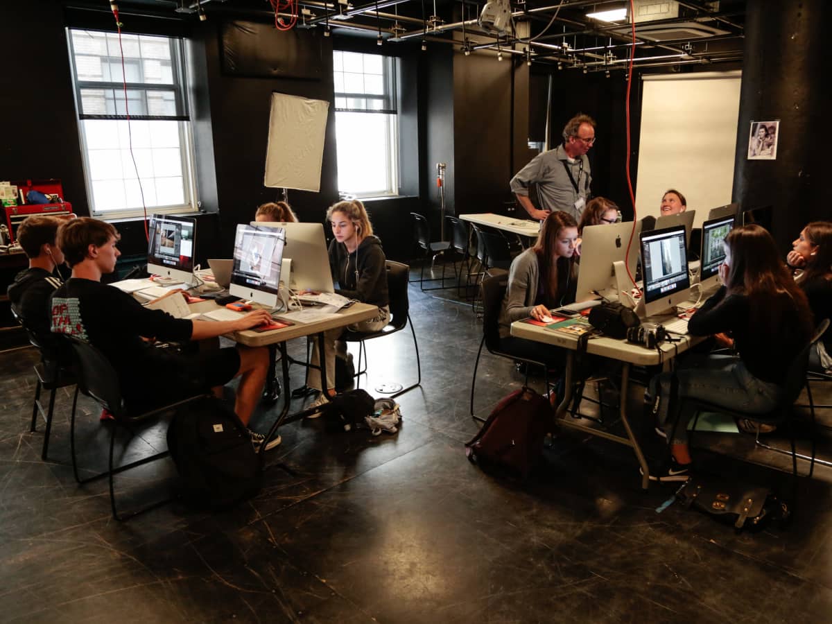 Photography students learning Lightroom