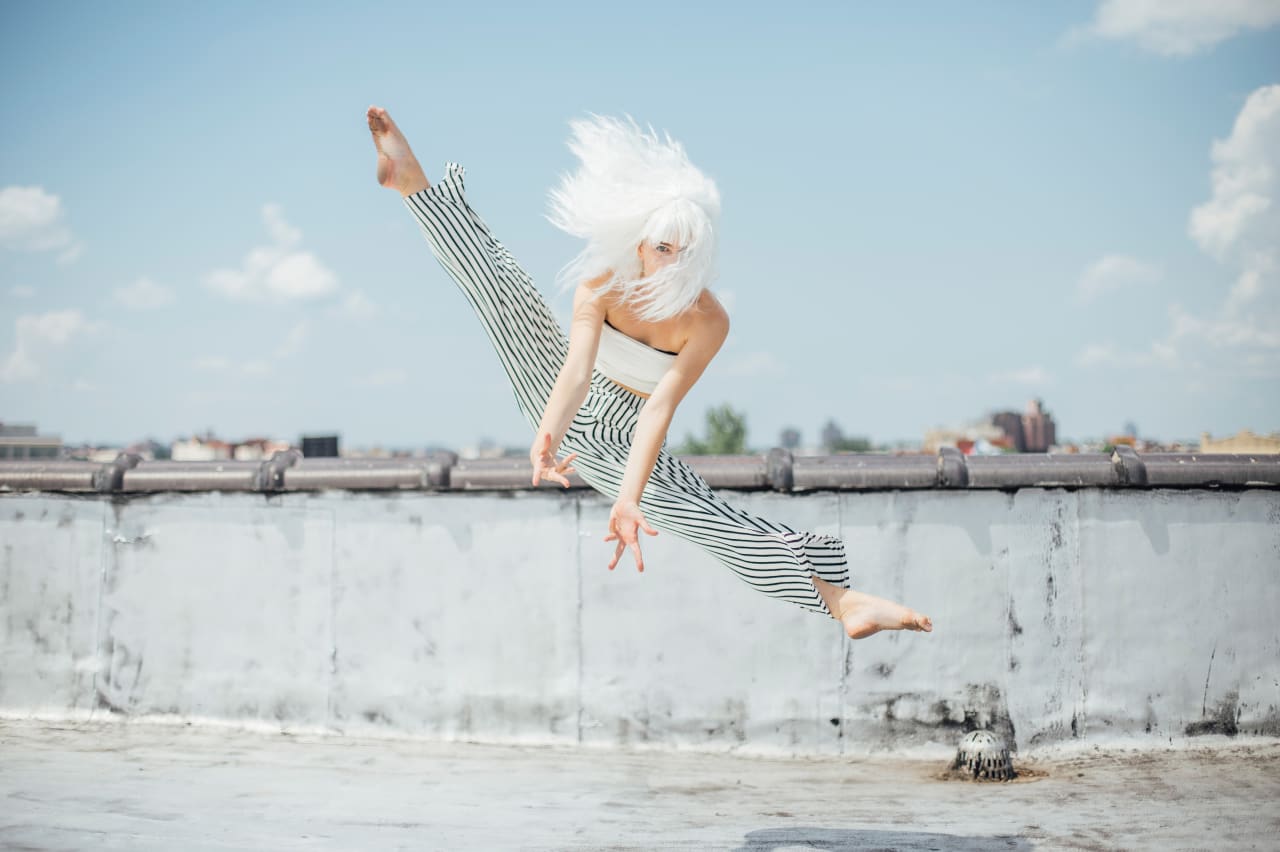 Teen solo dancer leaps on an NYC rooftop