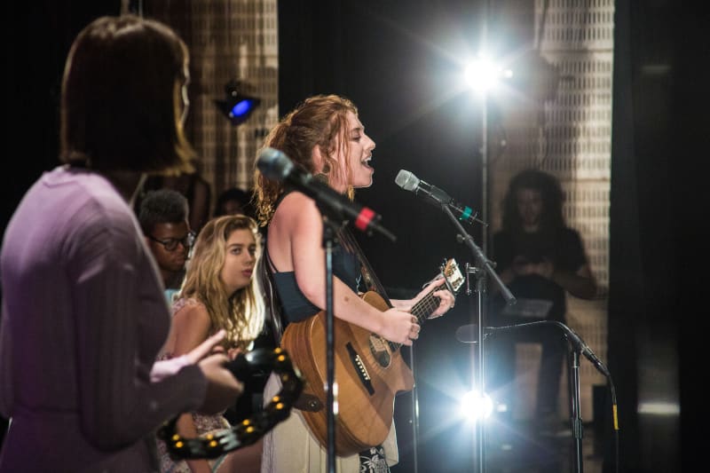 Advanced music students singing and performing