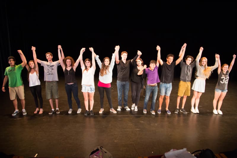 Teen actors taking bow on stage