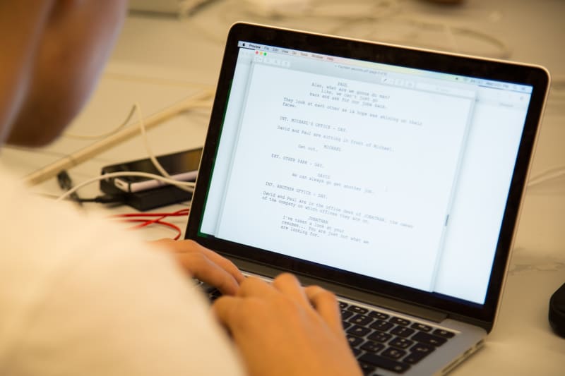 Screenwriting student at laptop