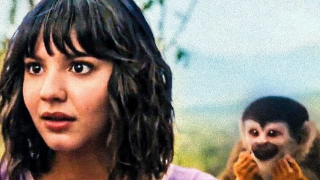 Samantha Lorraine as Dora in the jungle, with a monkey behind her
