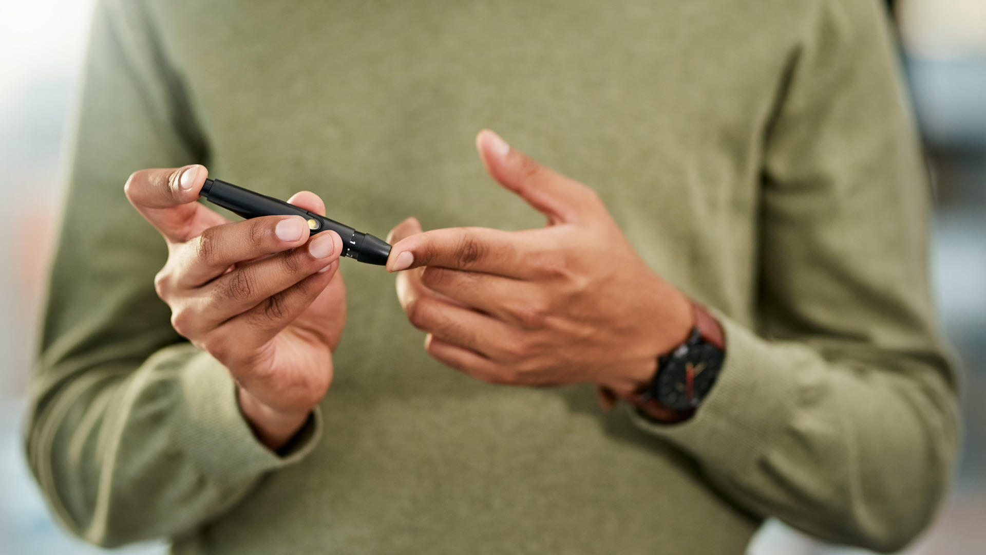 Man with diabetes testing blood sugar