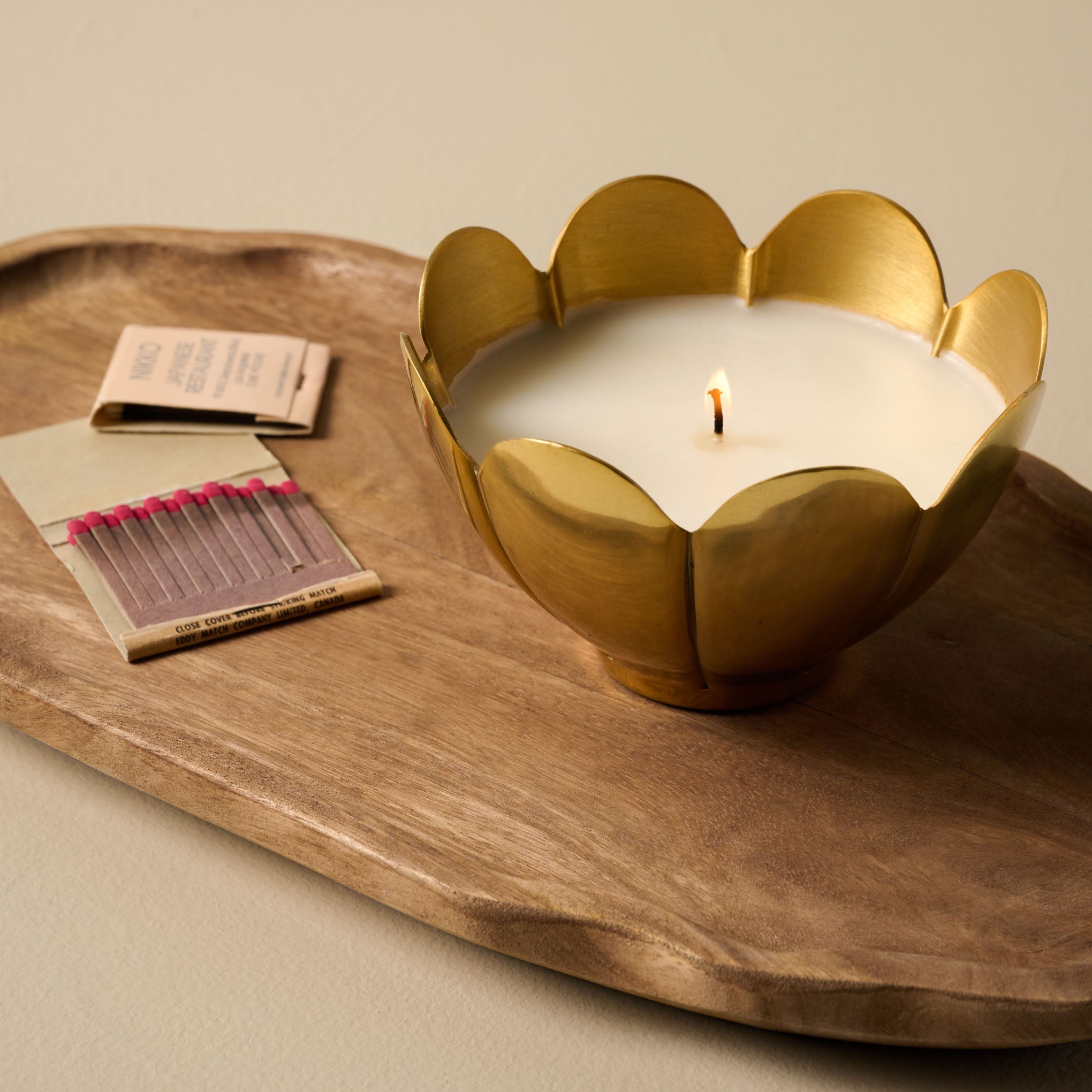 Magnolia Afternoon Wander Candle set on wooden tray with two matchbooks