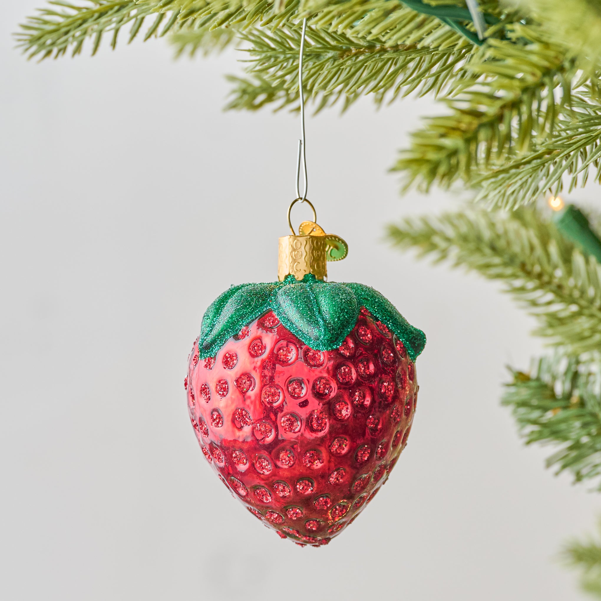 Strawberry Ornament shown on tree