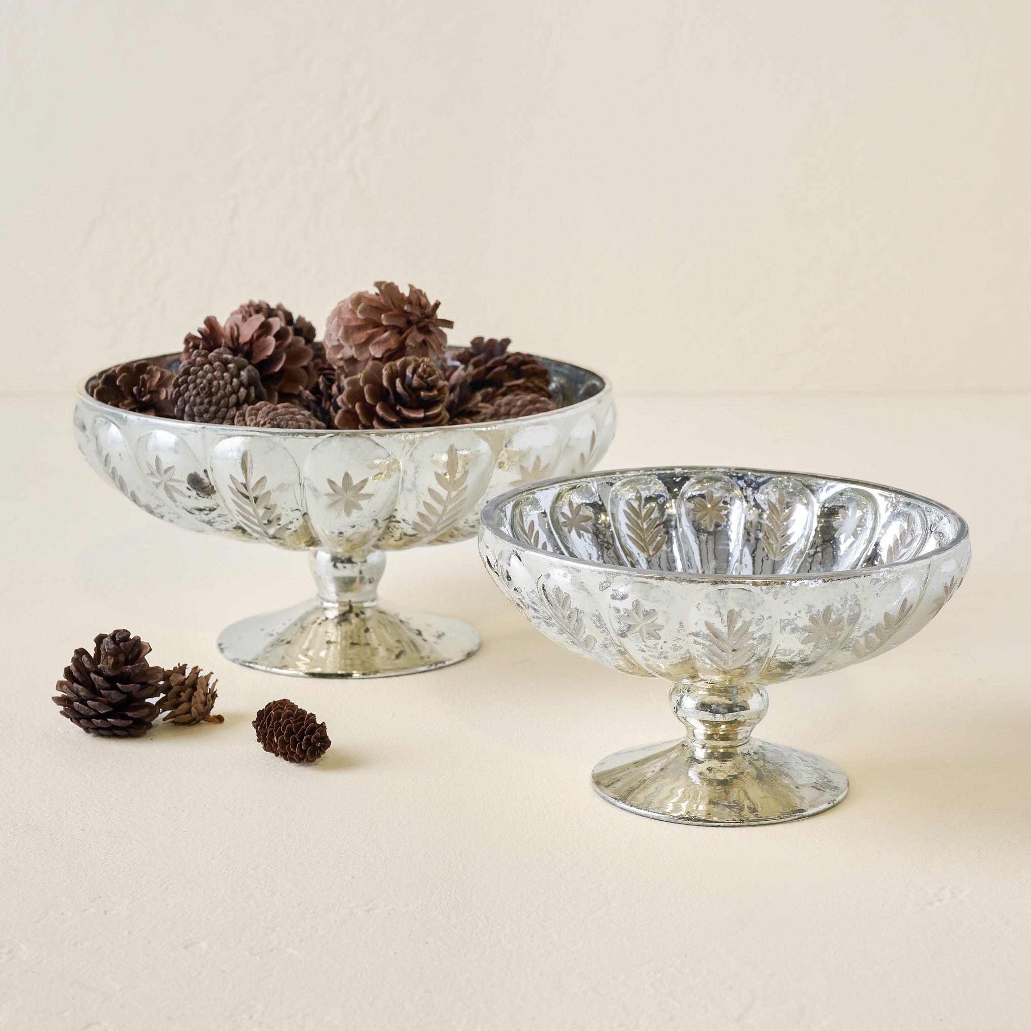 Small and LArge Etched Mercury Glass Compote Bowls shown  with pinecones