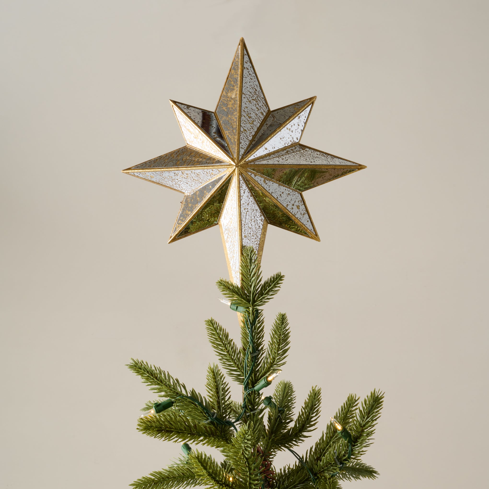 Gold Mercury Star Tree Topper shown on tree