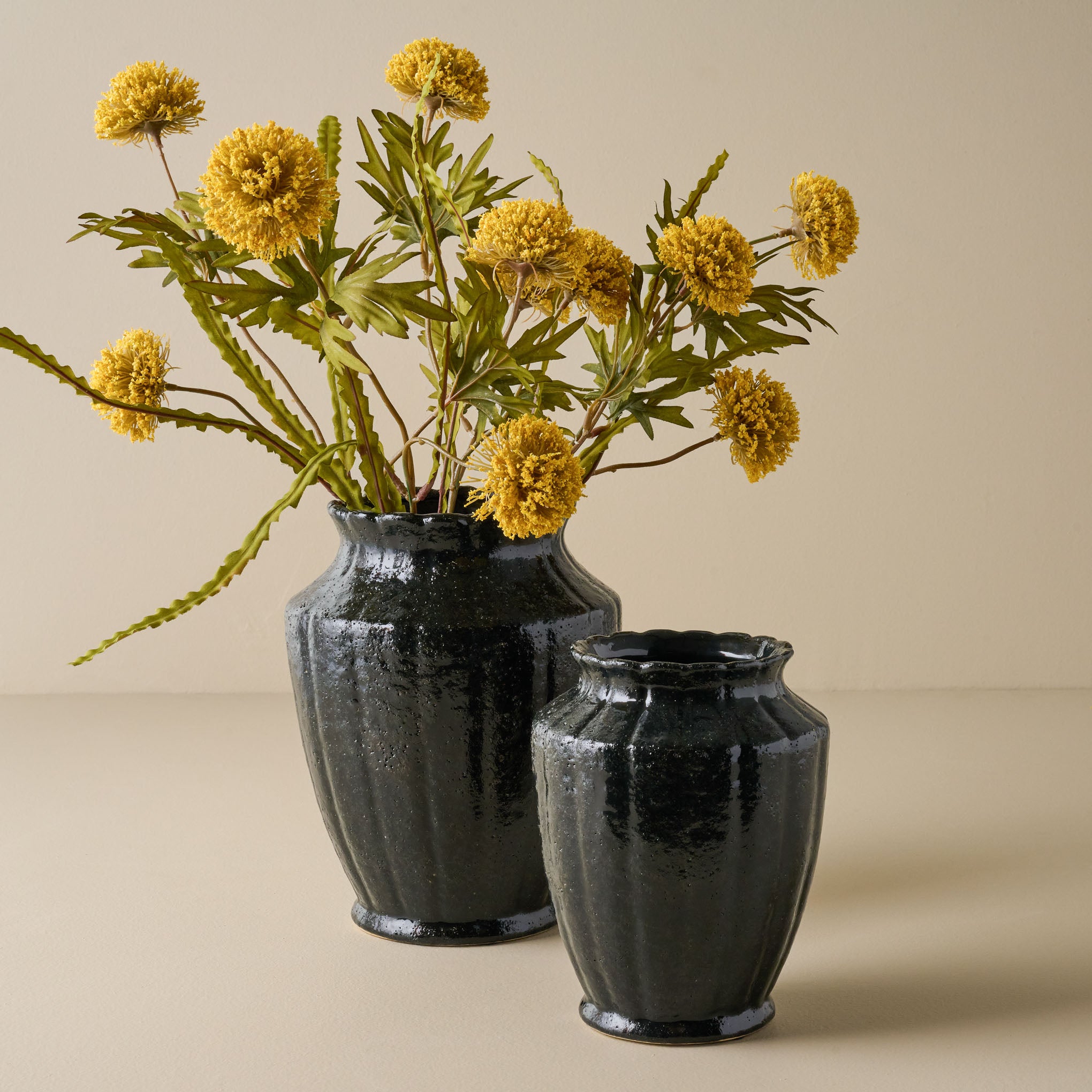 Small and Large Glazed Black Scalloped Vase shown with flowers