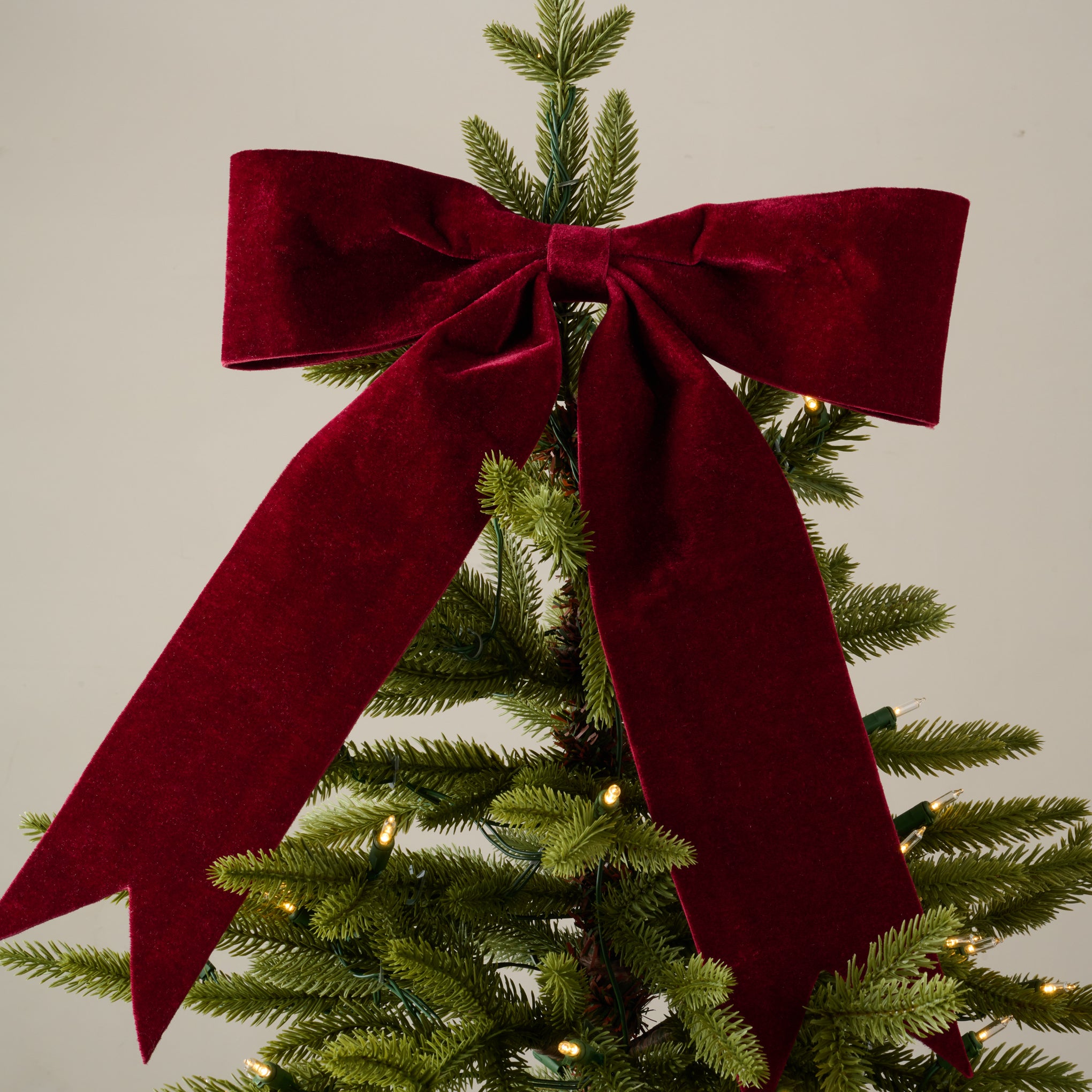 Red Bountiful Bow Tree Topper shown on tree