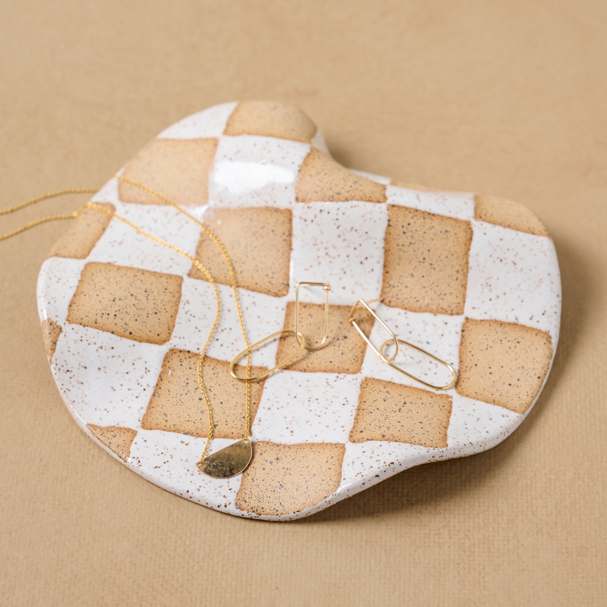 Checkered Wavy Trinket Dish holding jewelry