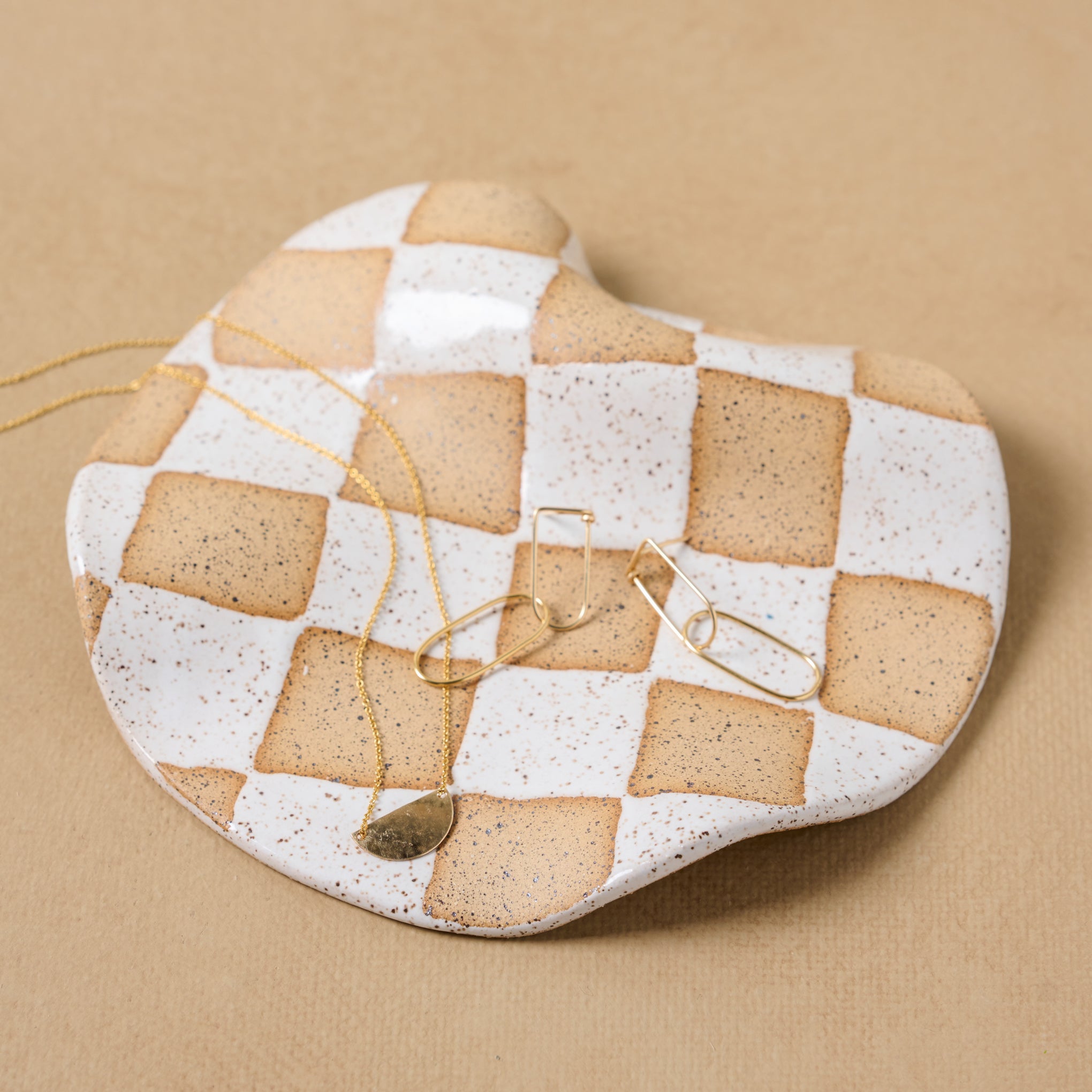 Checkered Wavy Trinket Dish holding jewelry On sale for $33.60, discounted from $42.00