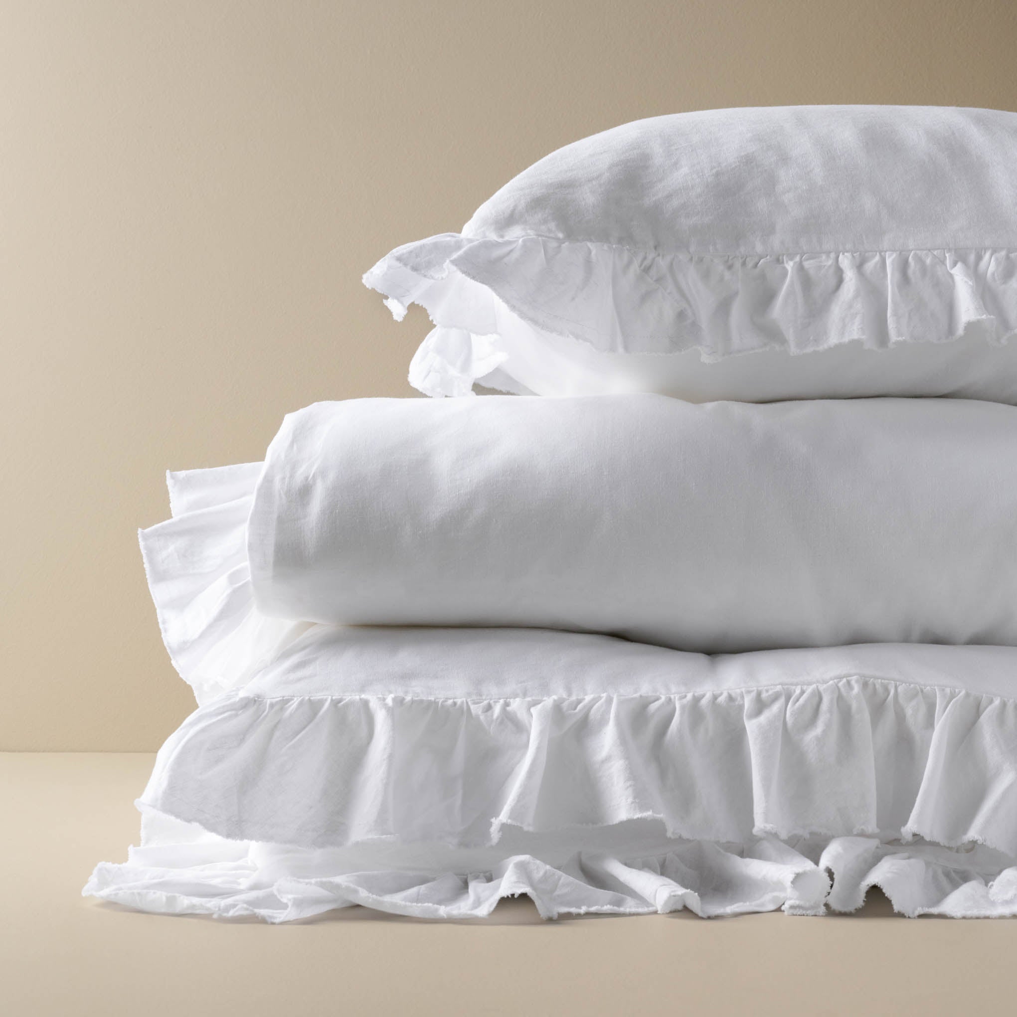 Optic White Ruffle Sham stacked on top of optic white ruffled duvet