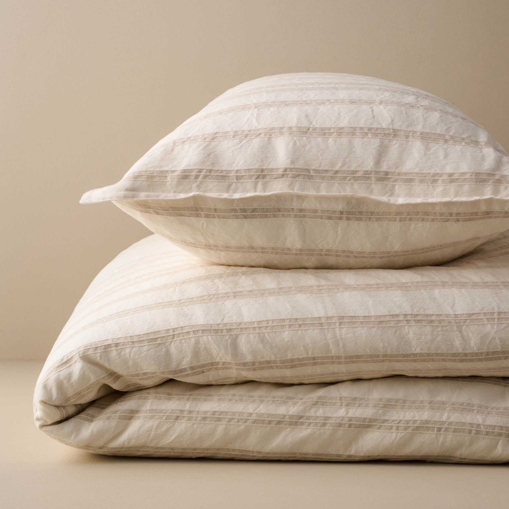 Folded Embroidered Oatmeal Stripe Linen Cotton Duvet and Pillow Sham Items range from $198.00 to $248.00