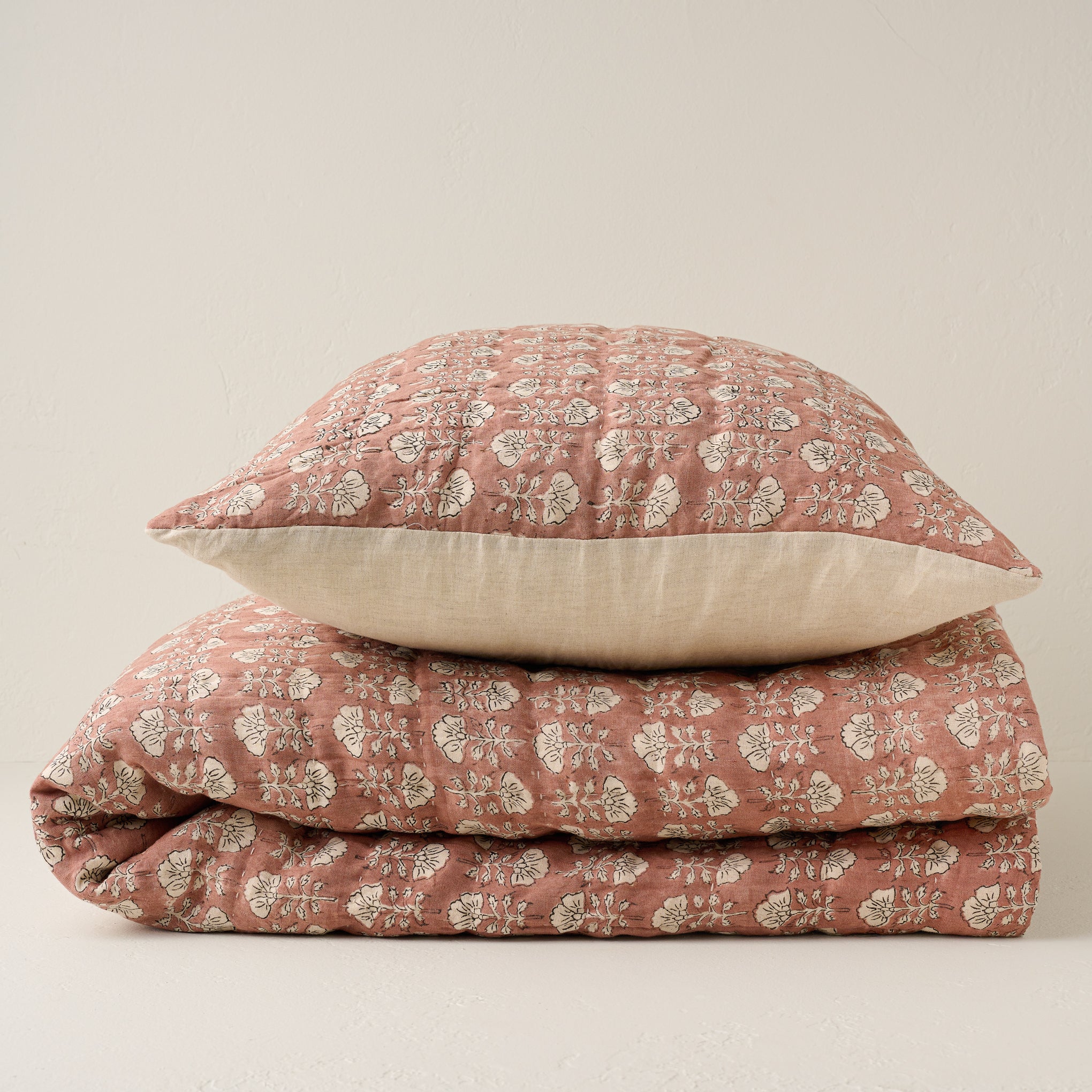 Stacked Flora Block Desert Clay Print Quilt and Pillow Sham Items range from $250.00 to $300.00