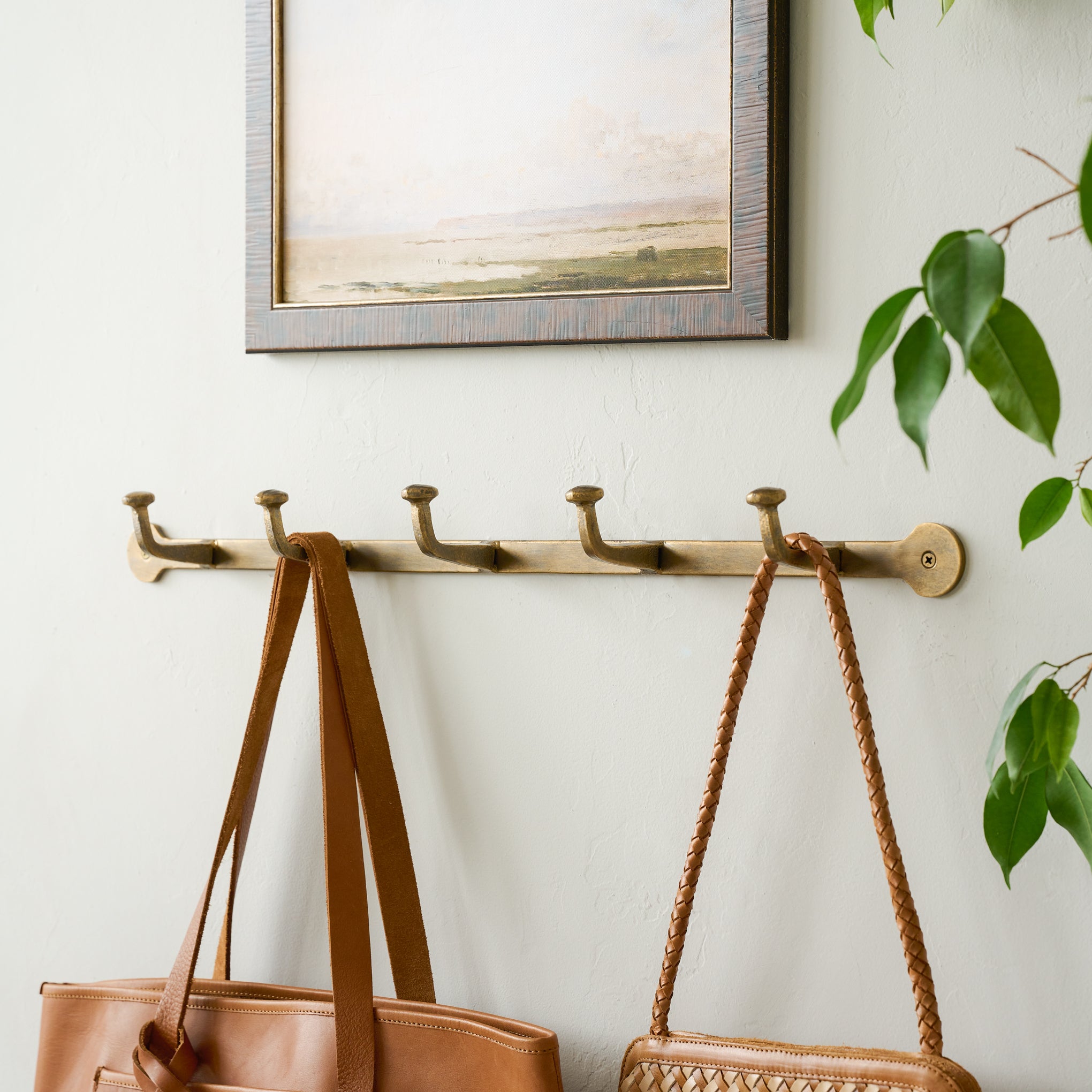 Hammered Iron Wall Hooks with purses hanging from hooks Items range from $28.00 to $38.00
