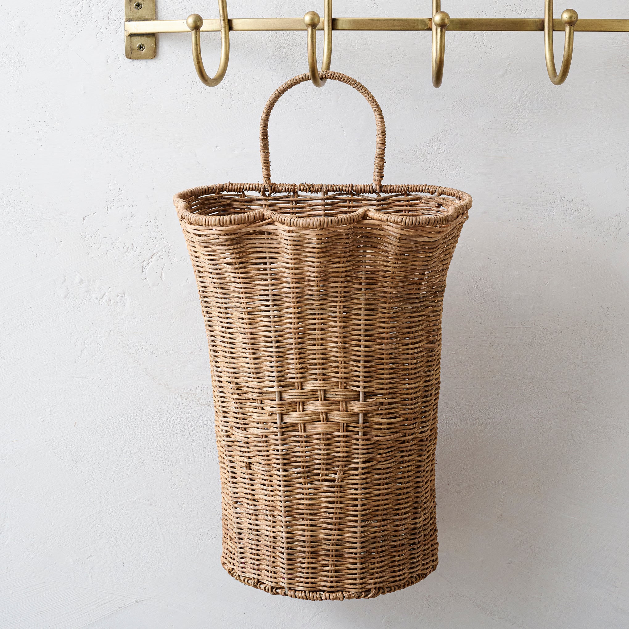 Woven Scalloped Wall Basket hanging on brass wall hook $54.00