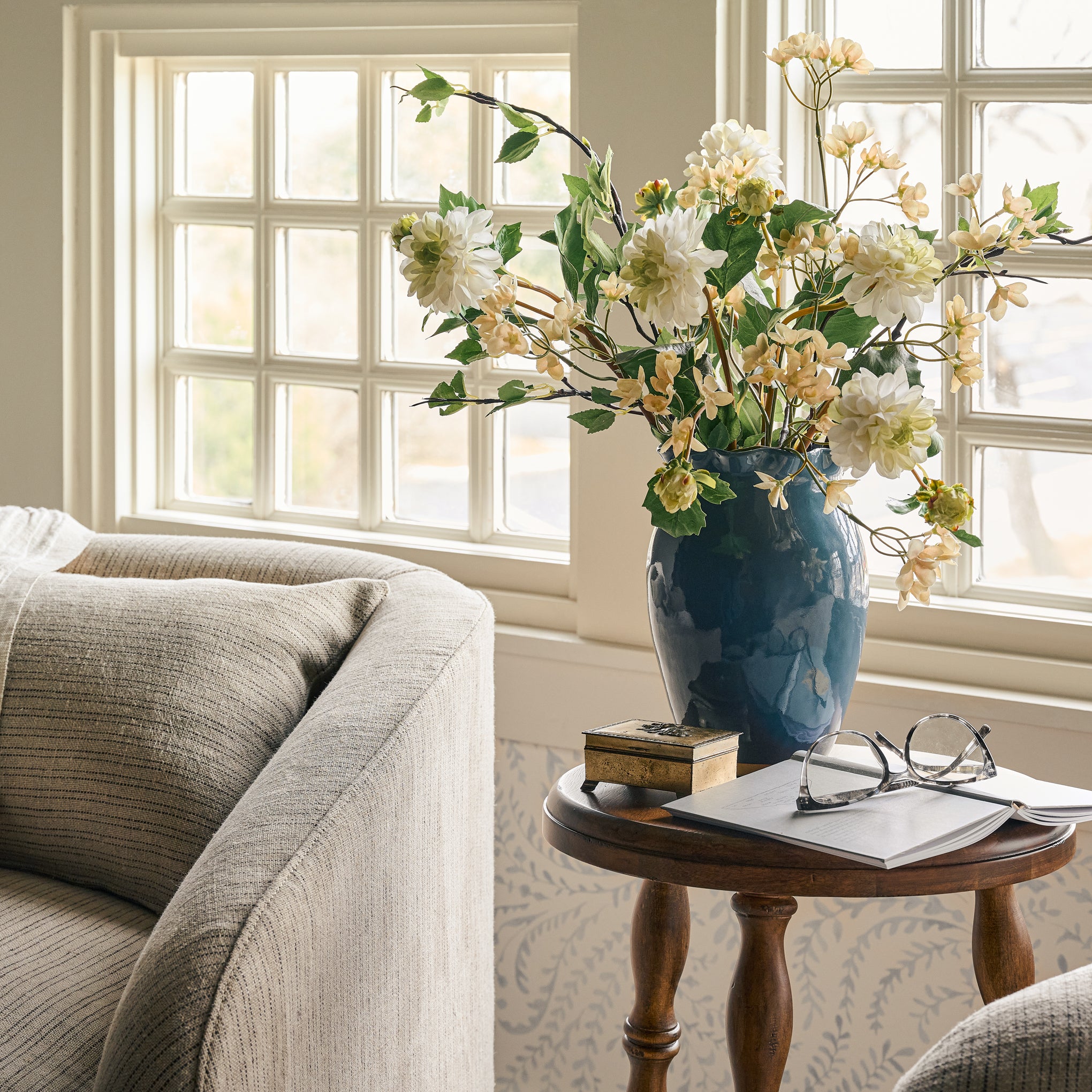 Nancy Blue Scalloped Ceramic Vase large on a side table with faux florals Items range from $20.00 to $32.00