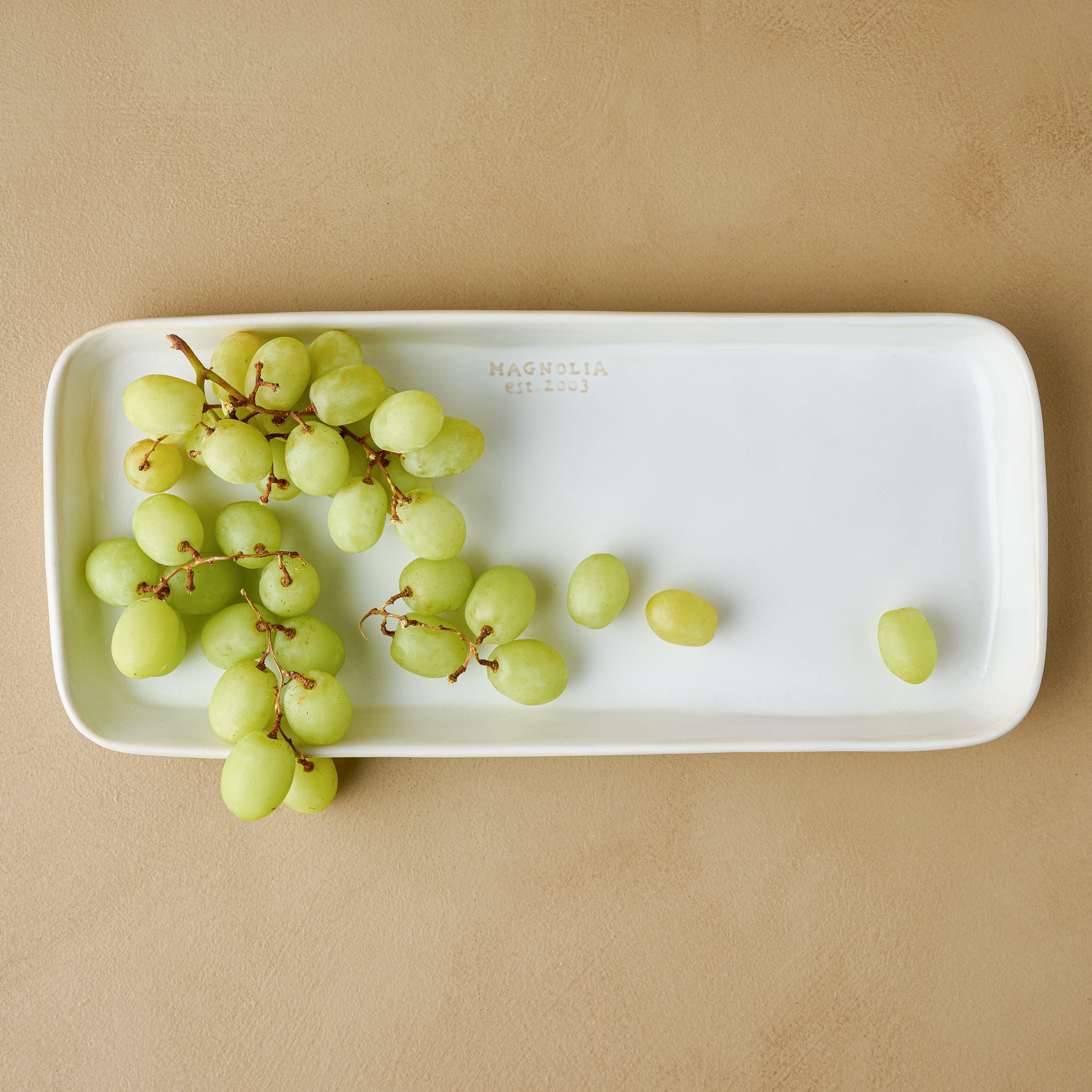 Magnolia Est. Ceramic Rectangular Platter with grapes on top Items range from $26.00 to $34.00