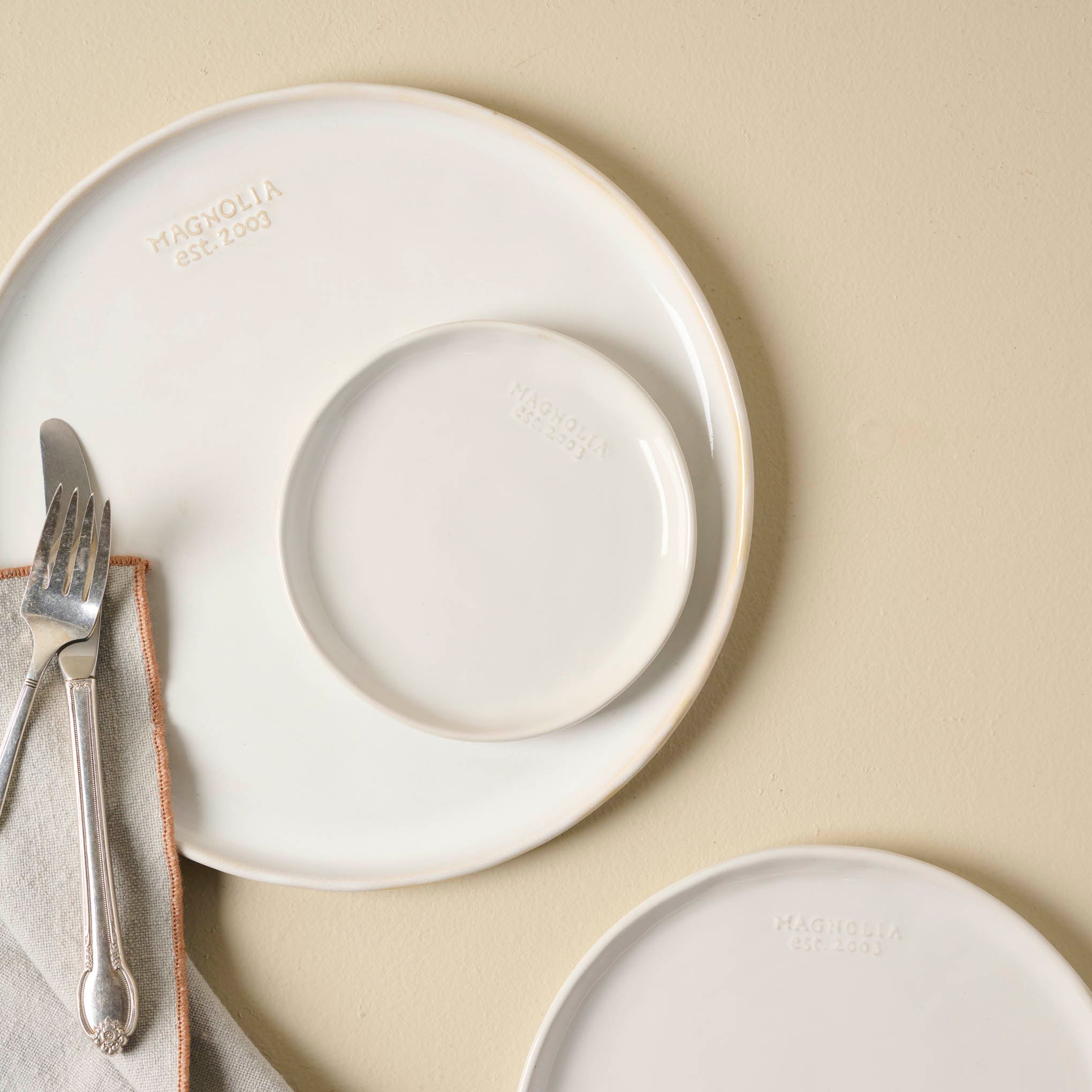 Magnolia Est. Plates in all 3 sizes shown with silverware Items range from $8.00 to $16.00