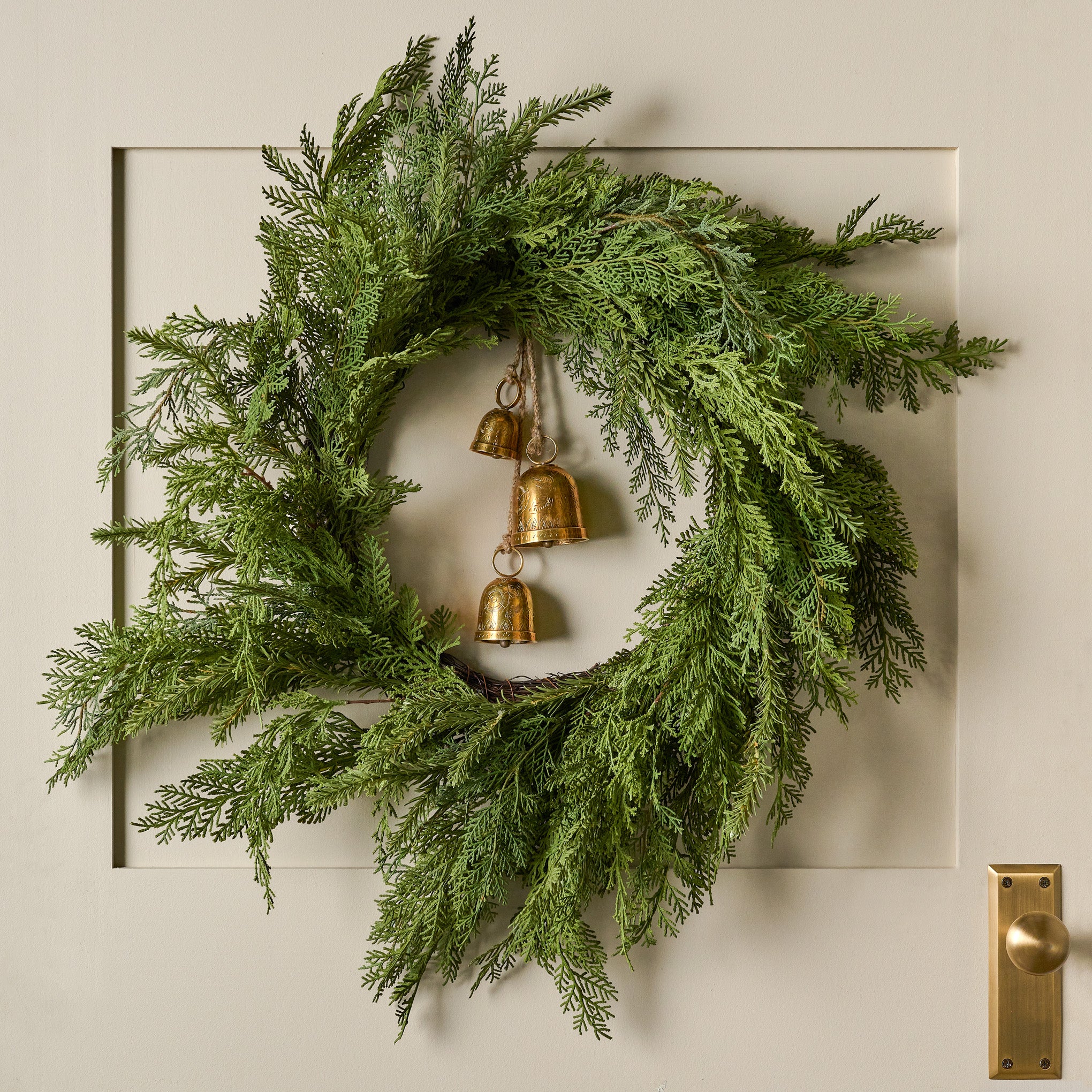 Real Touch Cedar Mix Wreath shown hung on door with bells