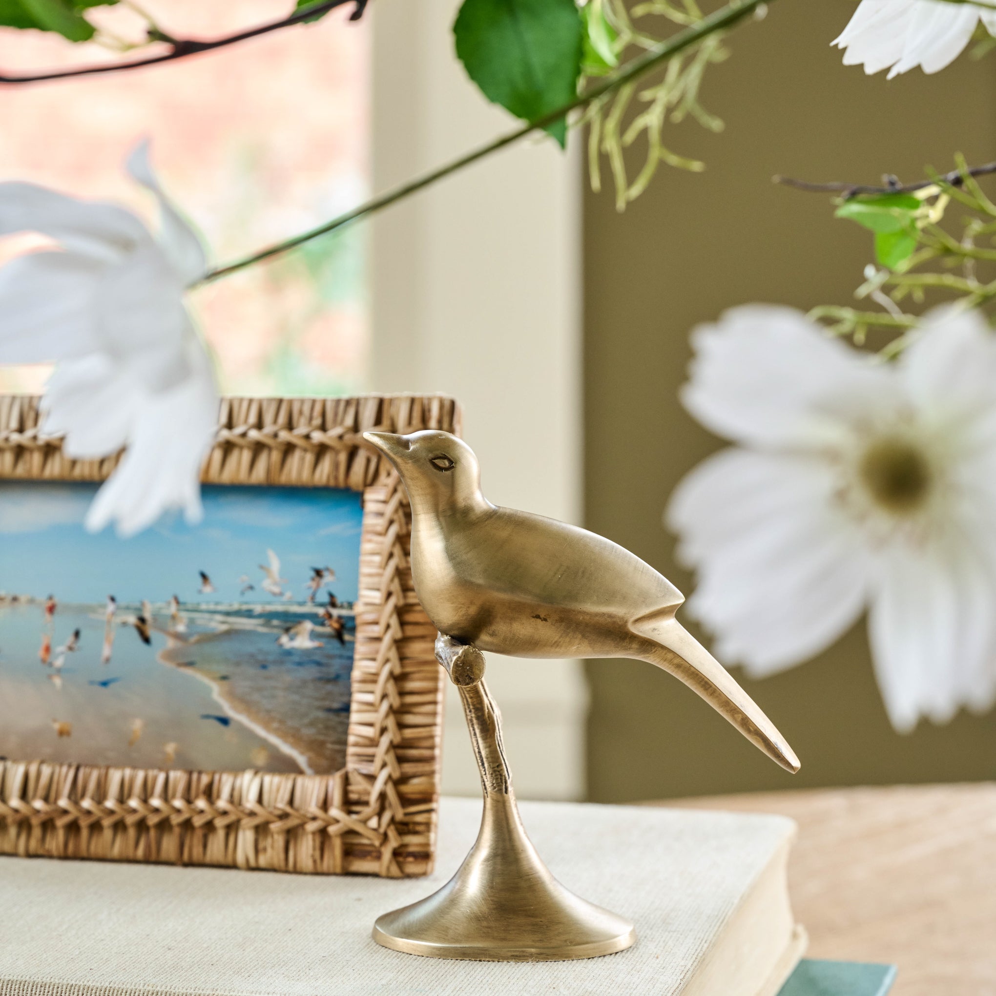 Brass Bird Sit About next to a picture frame