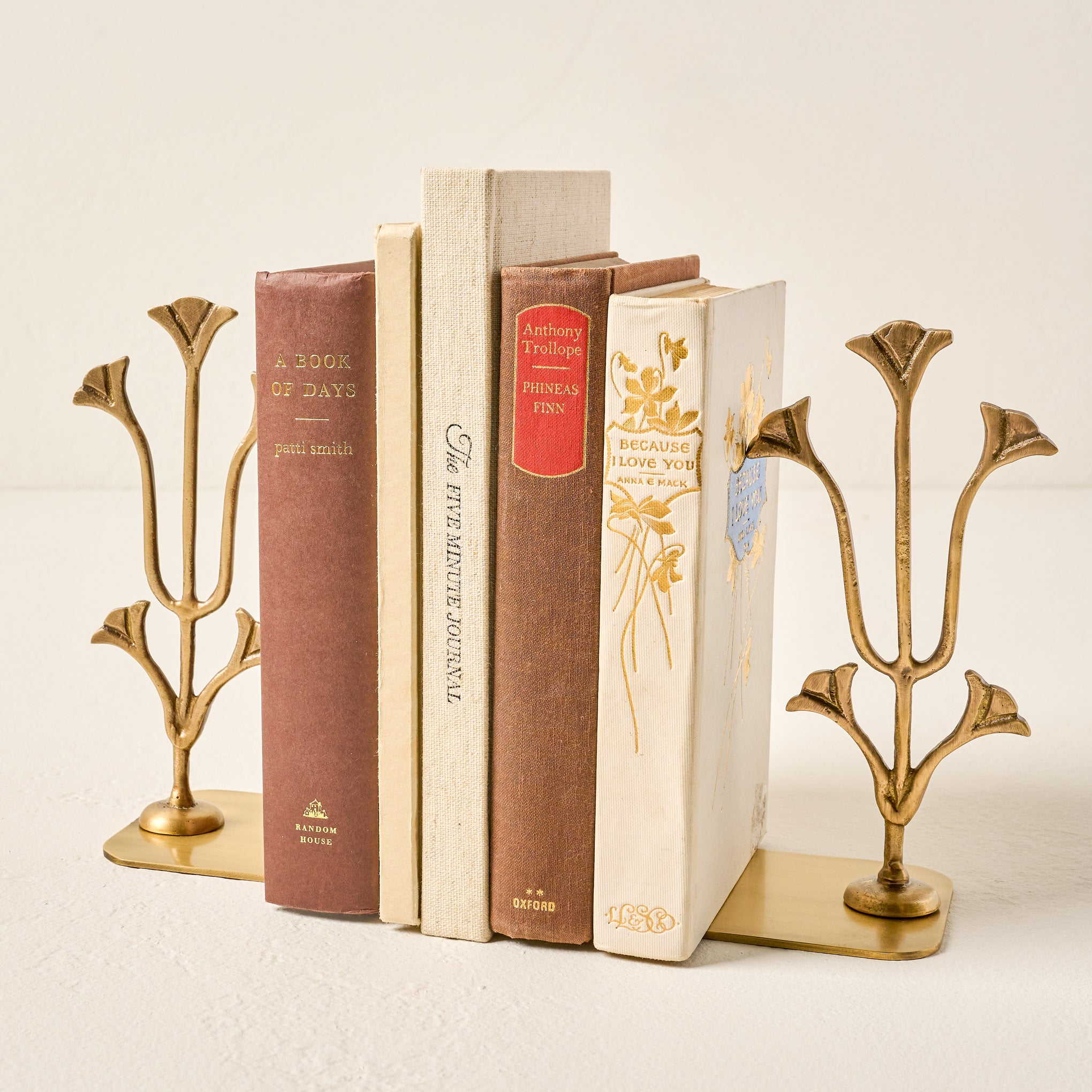 Antique Brass Tulip Bookends shown holding books