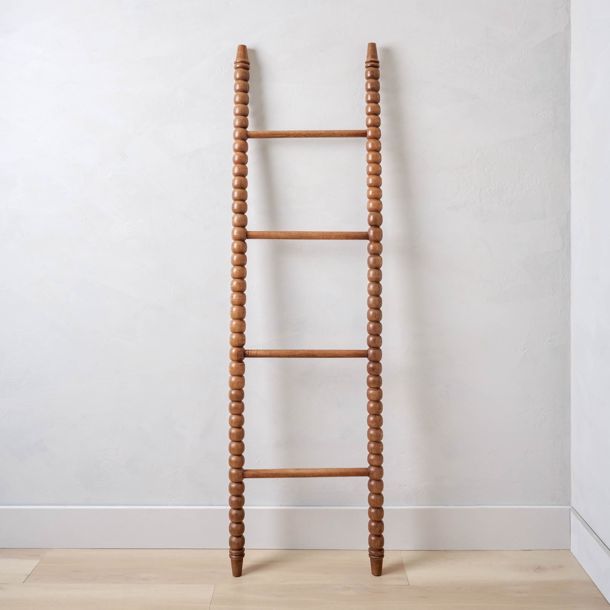 sylvie spindle ladder leaning against a wall $172.00