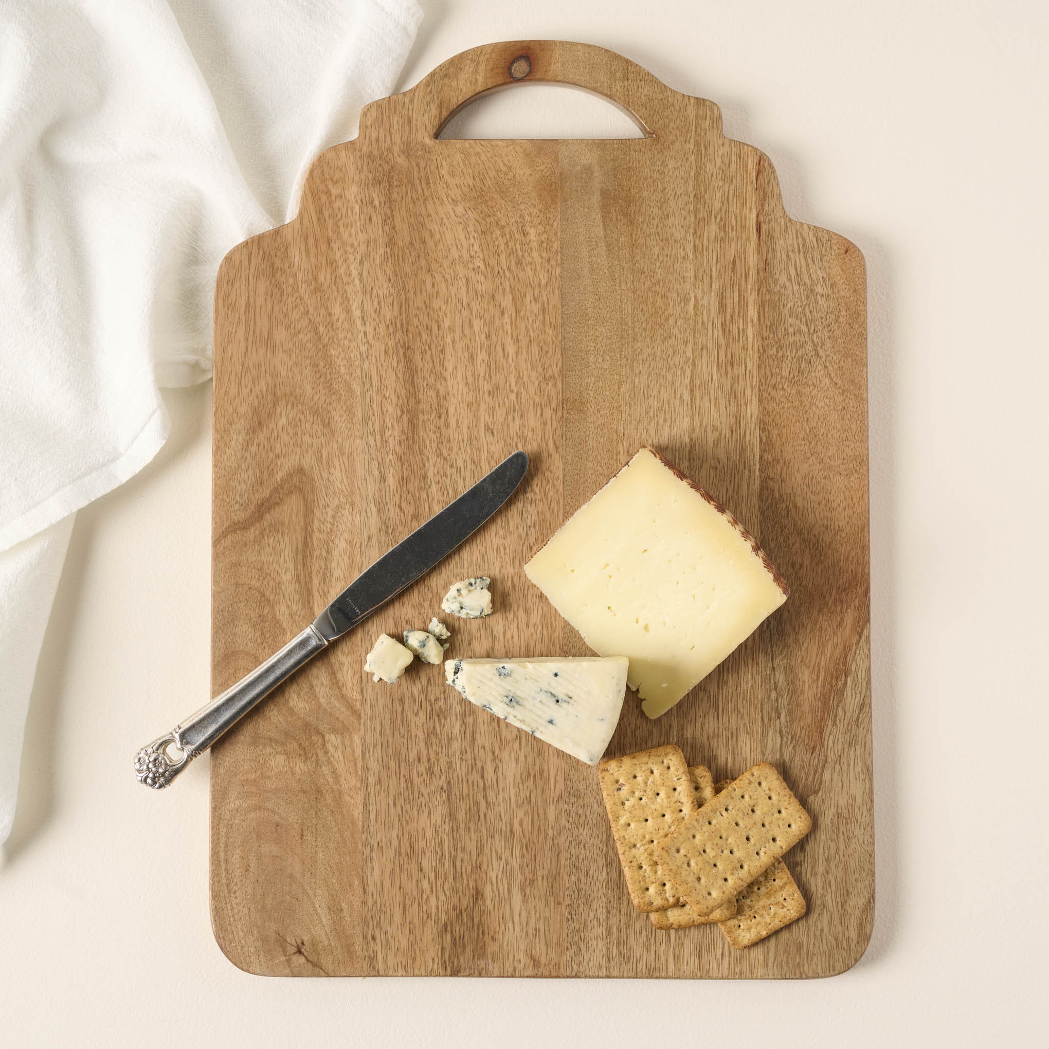 Ells Wooden Serving Board with cheese, crackers, and a butter knife on it On sale for $30.40, discounted from $38.00