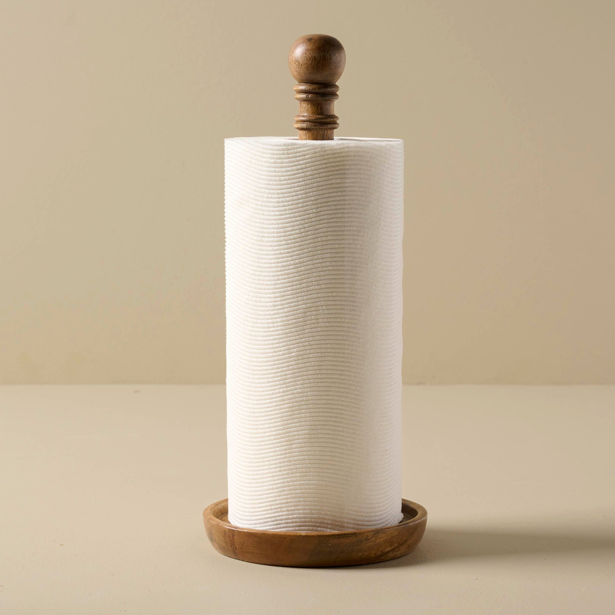 Antiqued Wood Paper Towel Holder with a roll of paper towel on it