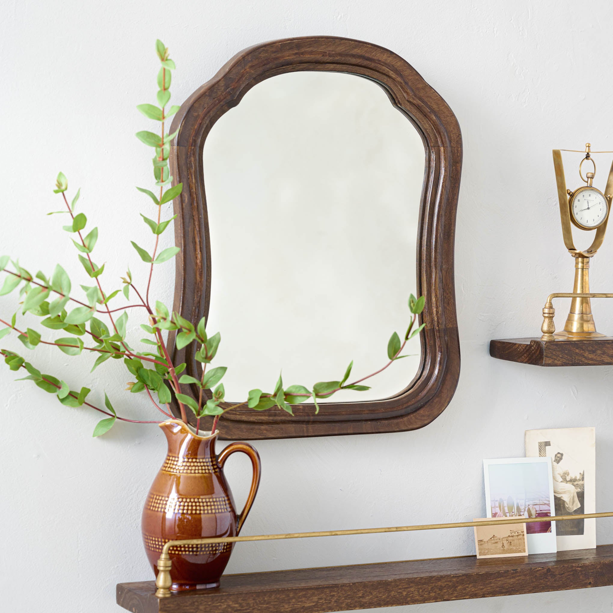 Thomas Shelf Mirror hung on a wall $68.00