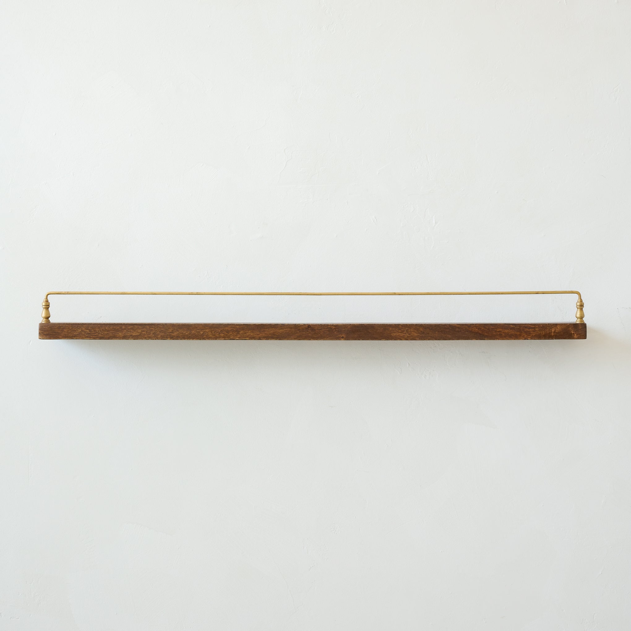 Elliott Wood and Brass Picture Ledge in large size hung on a wall