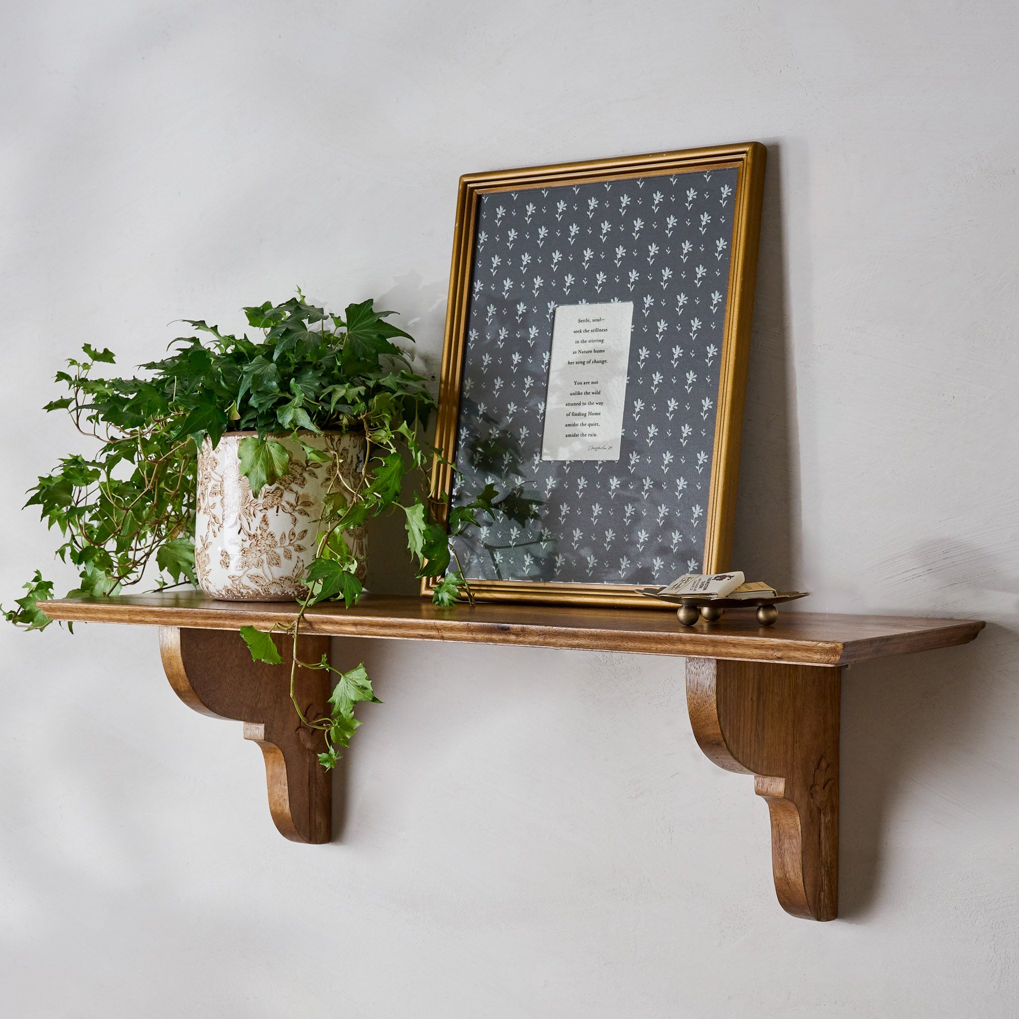 Dorothy Antiqued Wood Shelf shown with art and plants