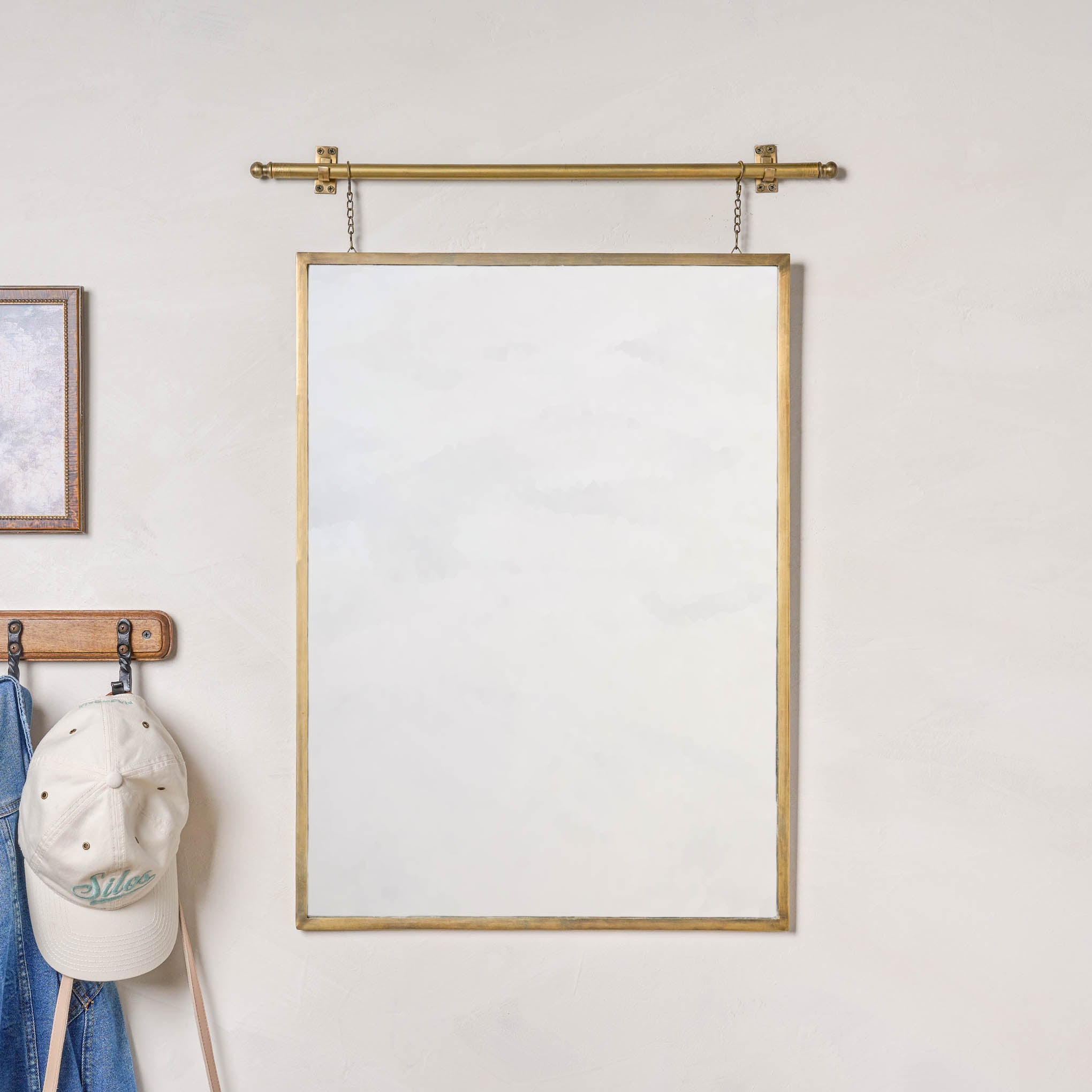 Colleen Brass Rail Wall Mirror next to a hat rack $134.00