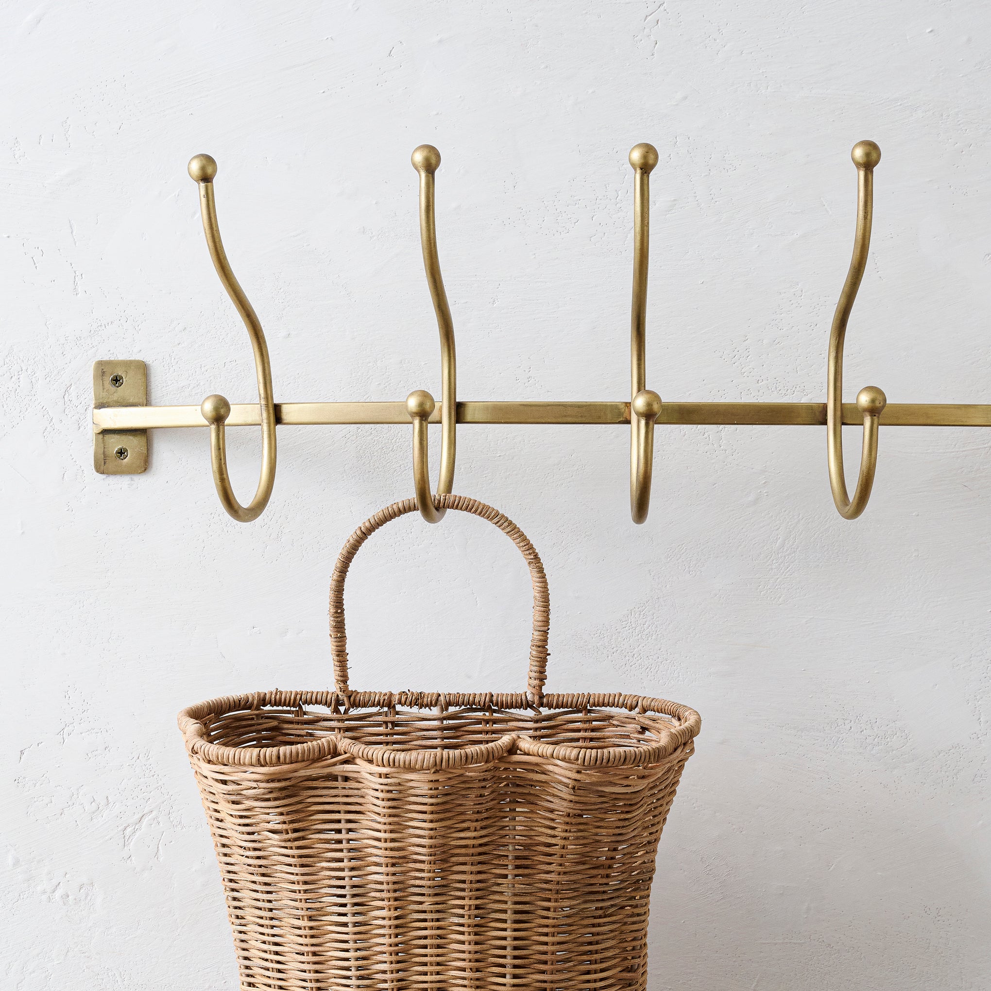 Webster Antique Brass Hook Rack holding a wicker basket $58.00