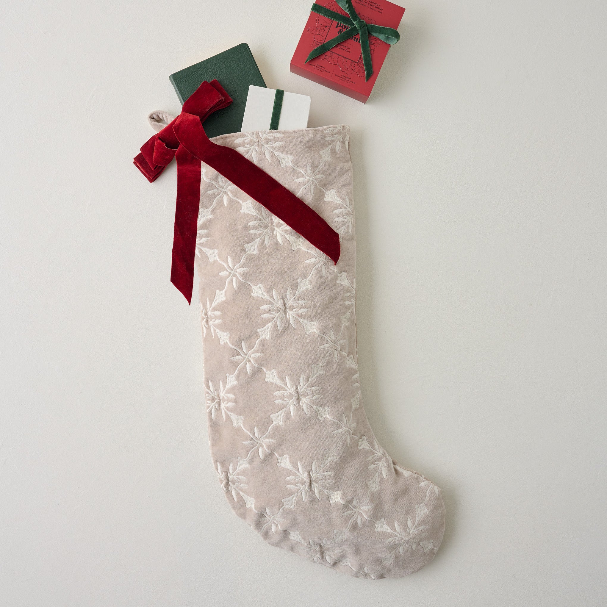 Aurora Embroidered Velvet Stocking shown with goods spilling out