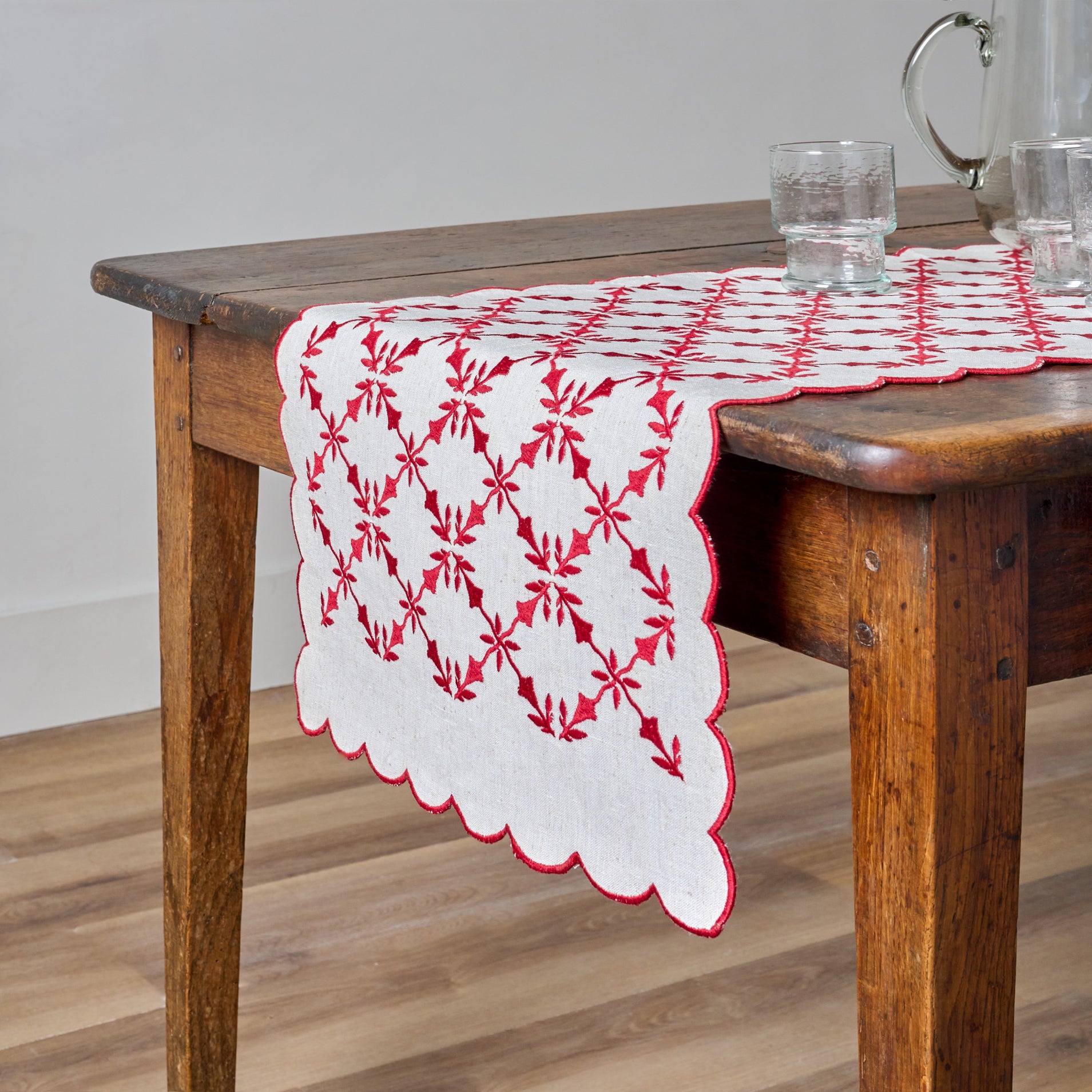 Red Laurie Embroidered Table Runner shown on table