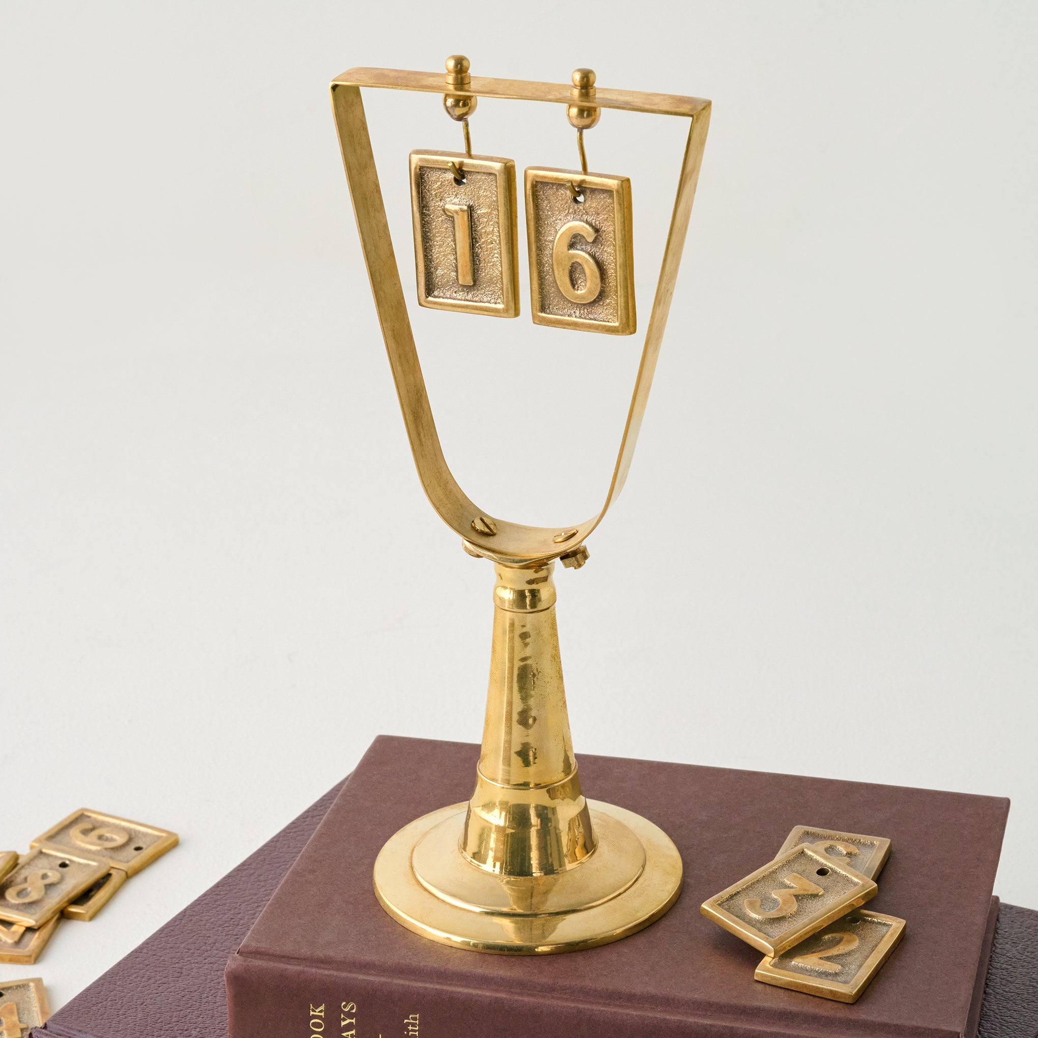 Solid Brass Countdown to Christmas shown on stack of books