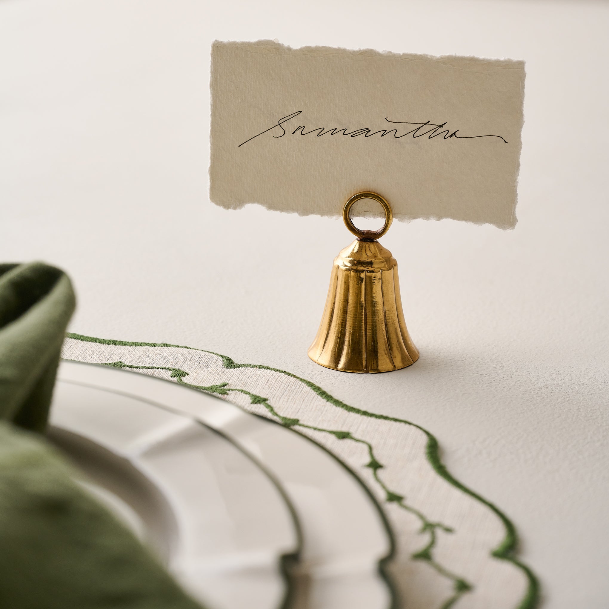 Brass Bell Place Card Holder shown holding card