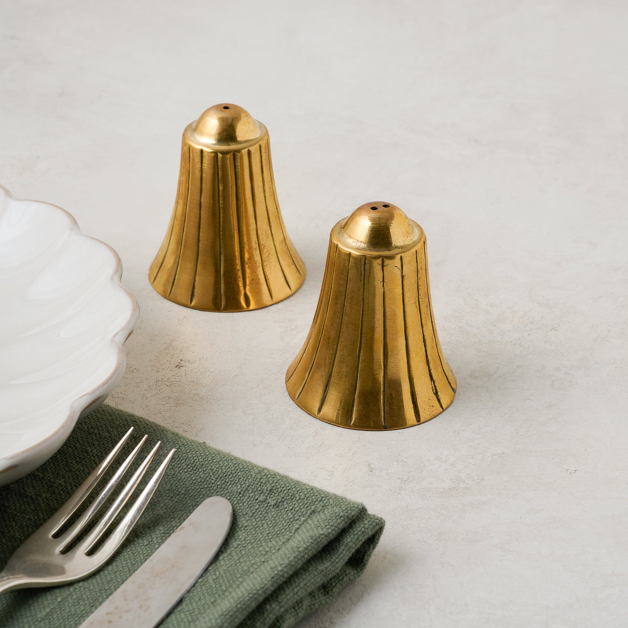 Brass Bell Salt + Pepper Set shown with place setting