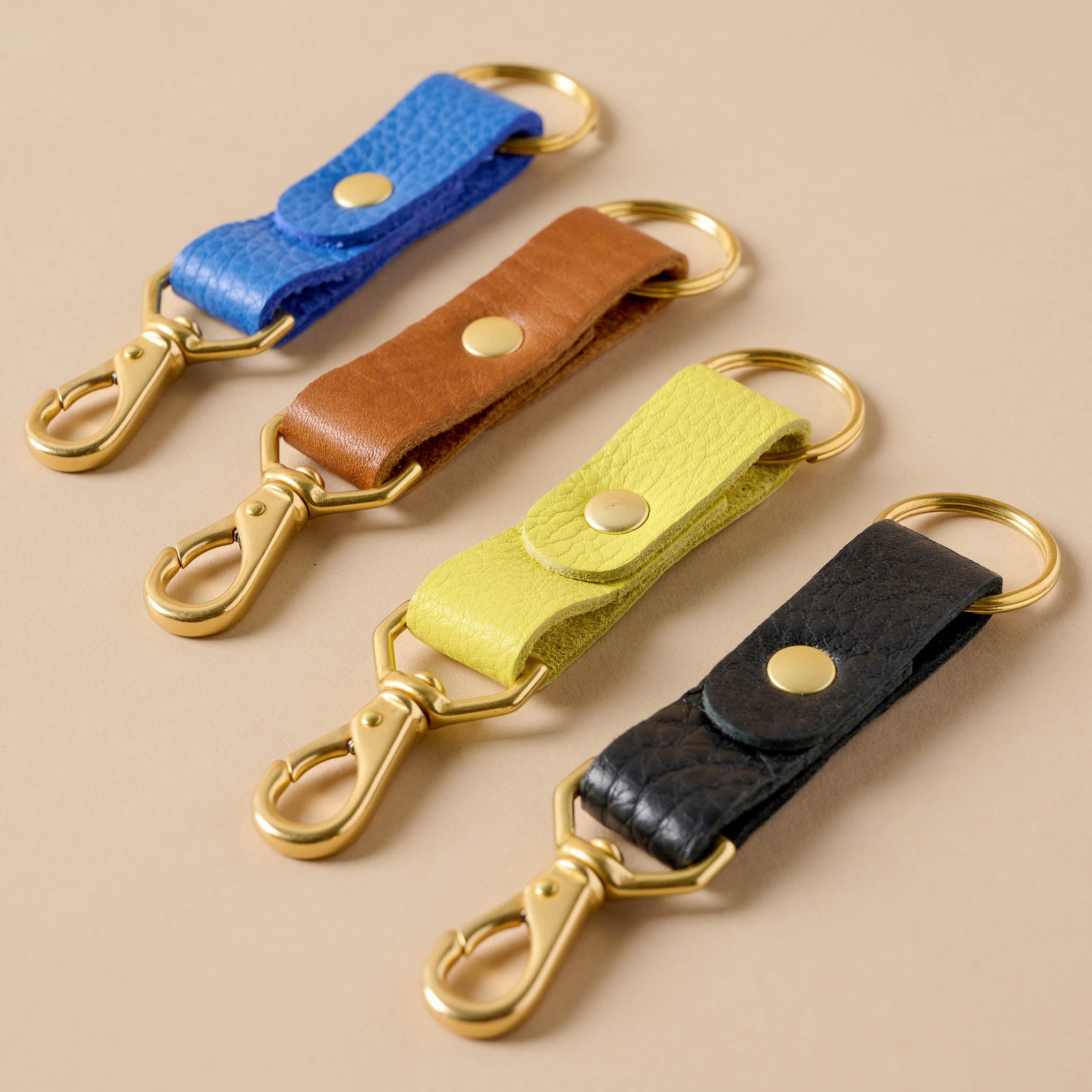 Luna Leather Keychain in blue, yellow, cognac, and black On sale for $14.40, discounted from $18.00