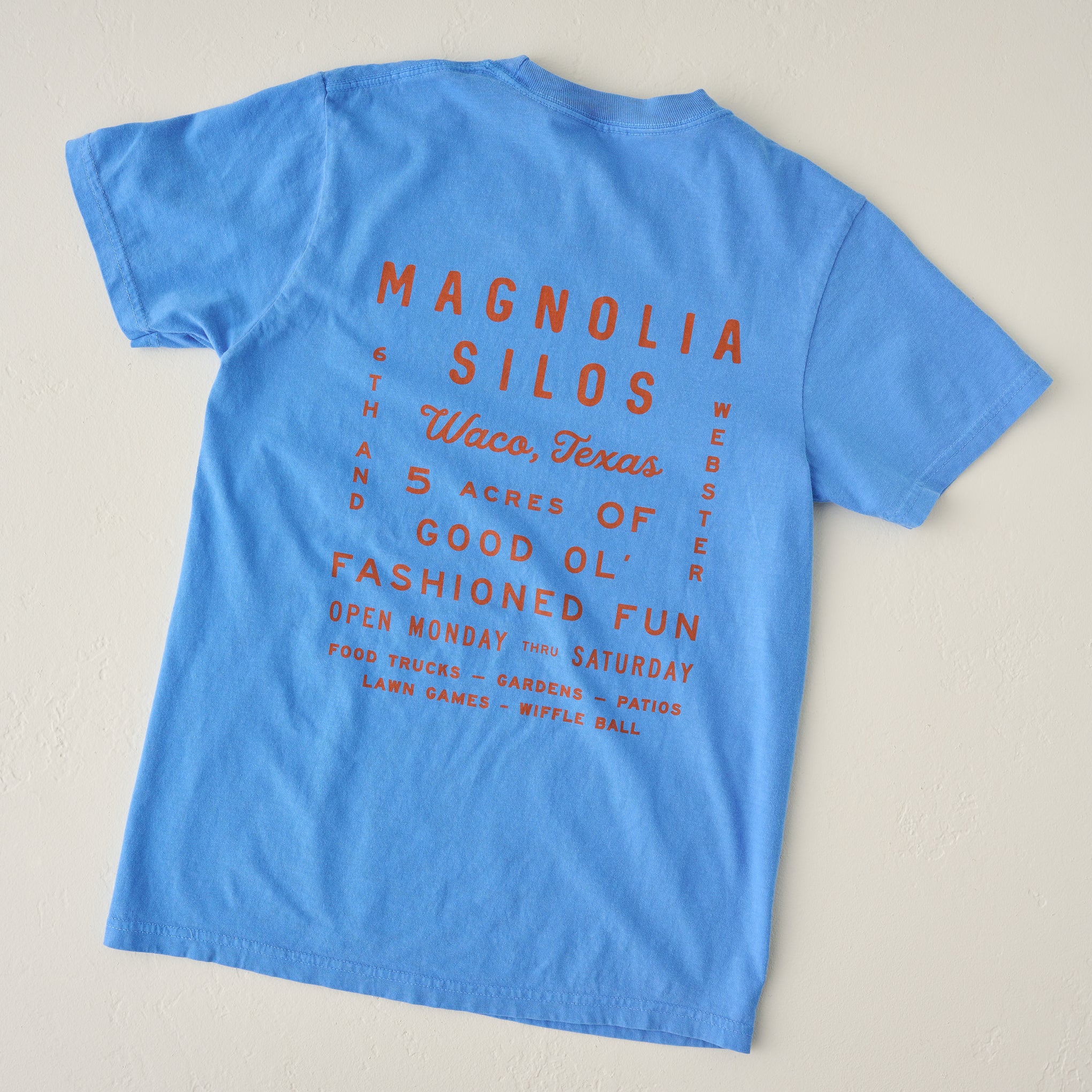 Magnolia Roadtrip Bright Blue Shirt close up of design on back of shirt