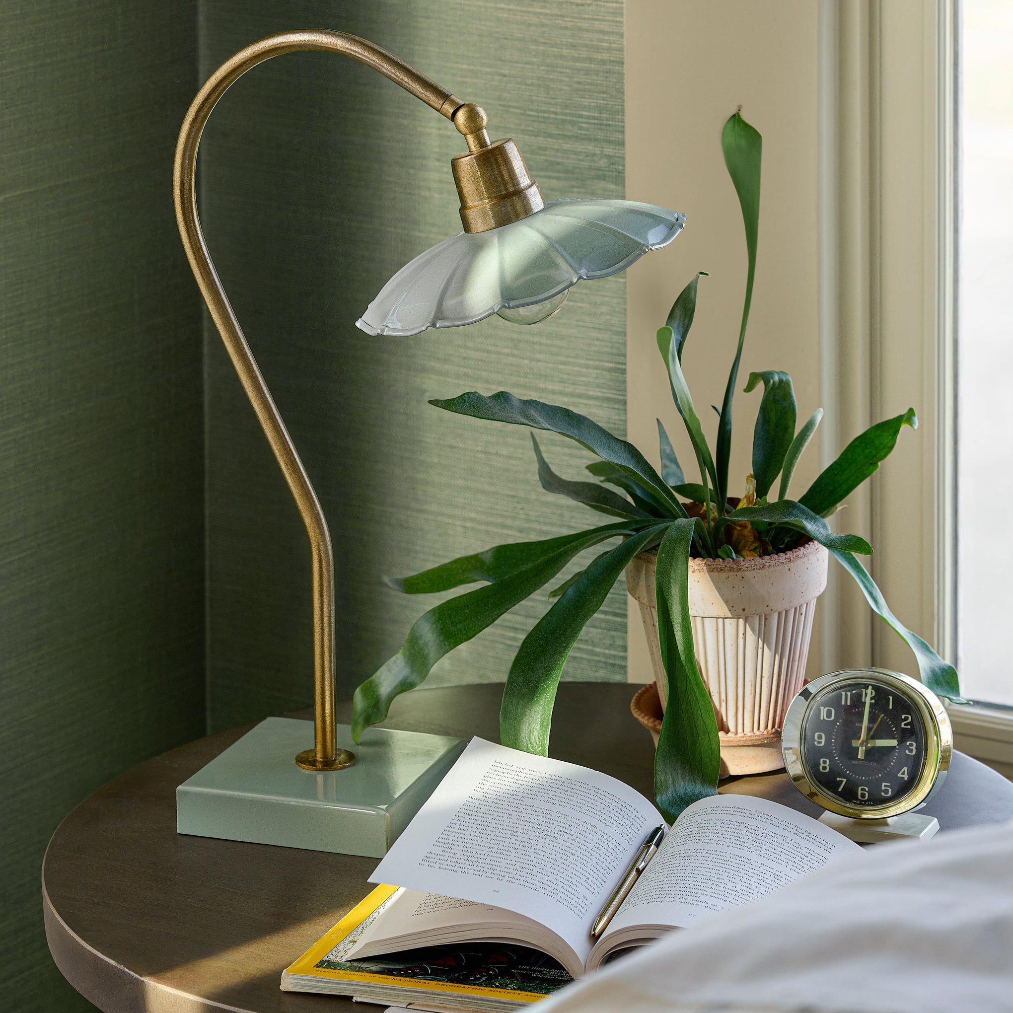 Lamp in seafoam on a nightstand with a plant $128.00