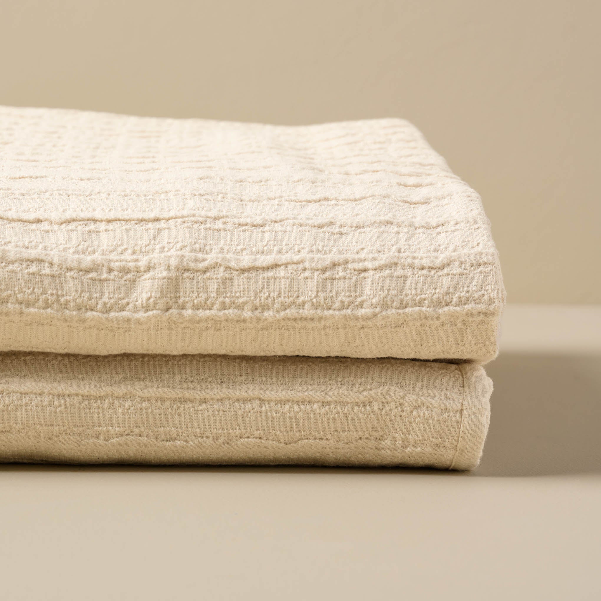 Folded Cream Textured Stripe Coverlet Items range from $140.00 to $160.00