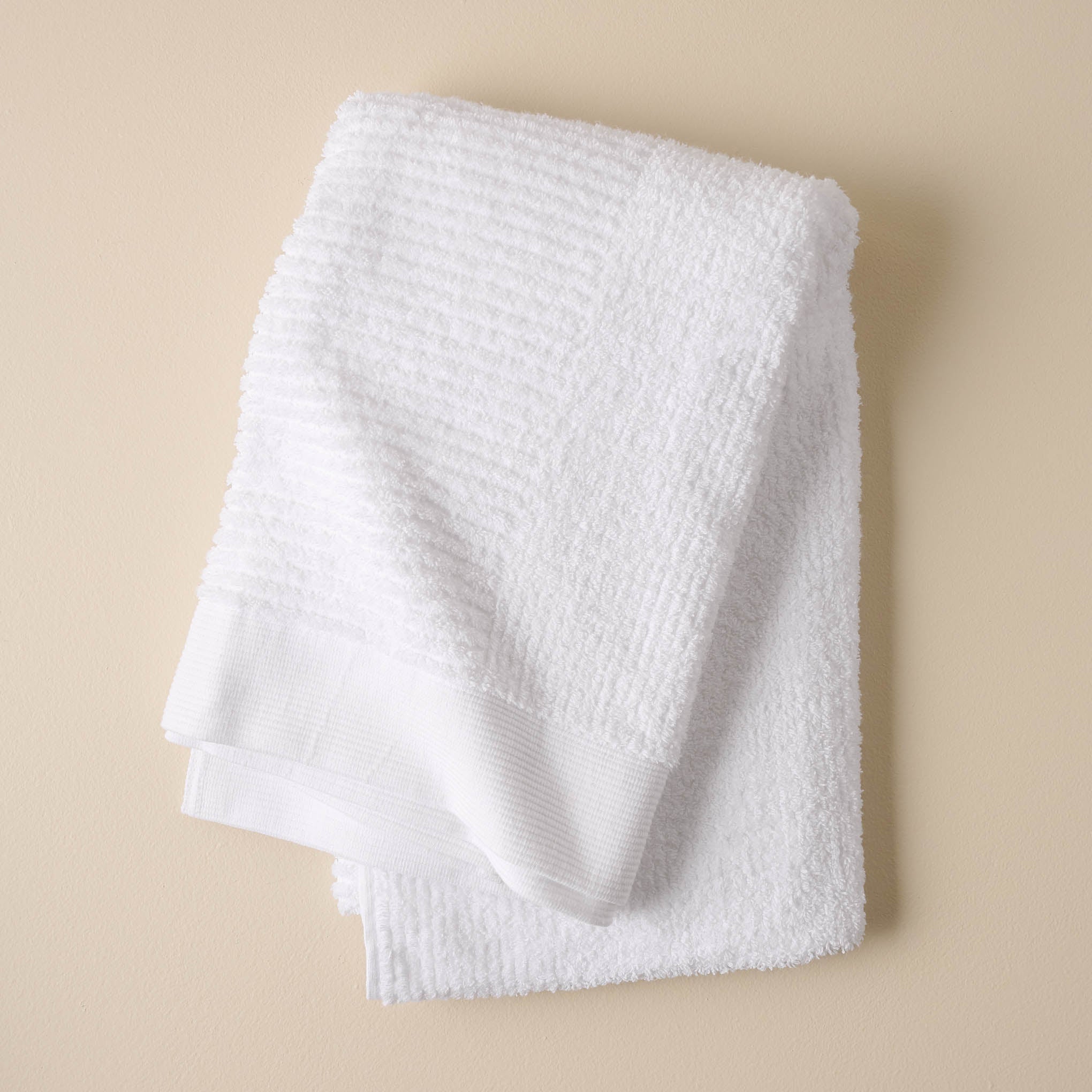 folded white textured bath towel