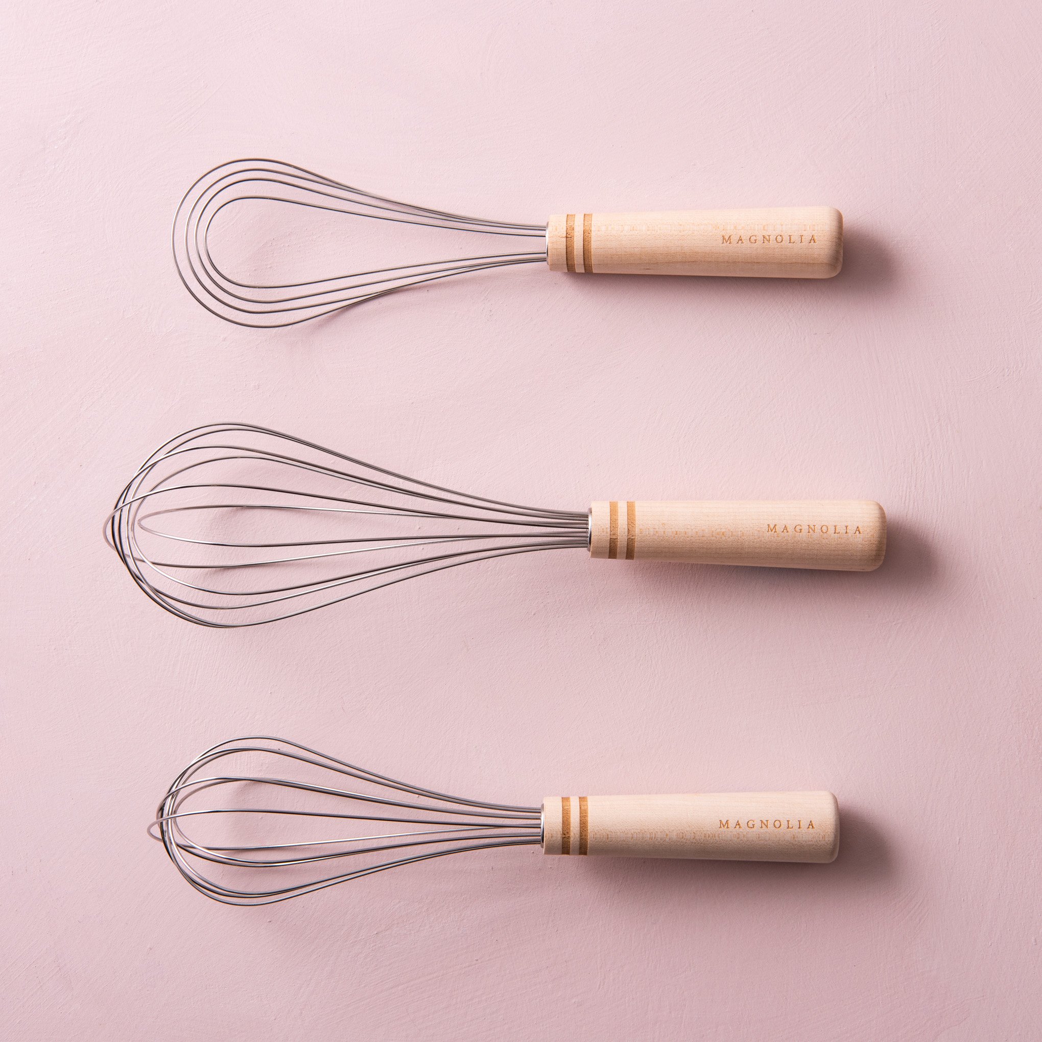 stainless steel whisk with embossed magnolia logo on maple wood handleOn sale for $5.60, discounted from $14.00