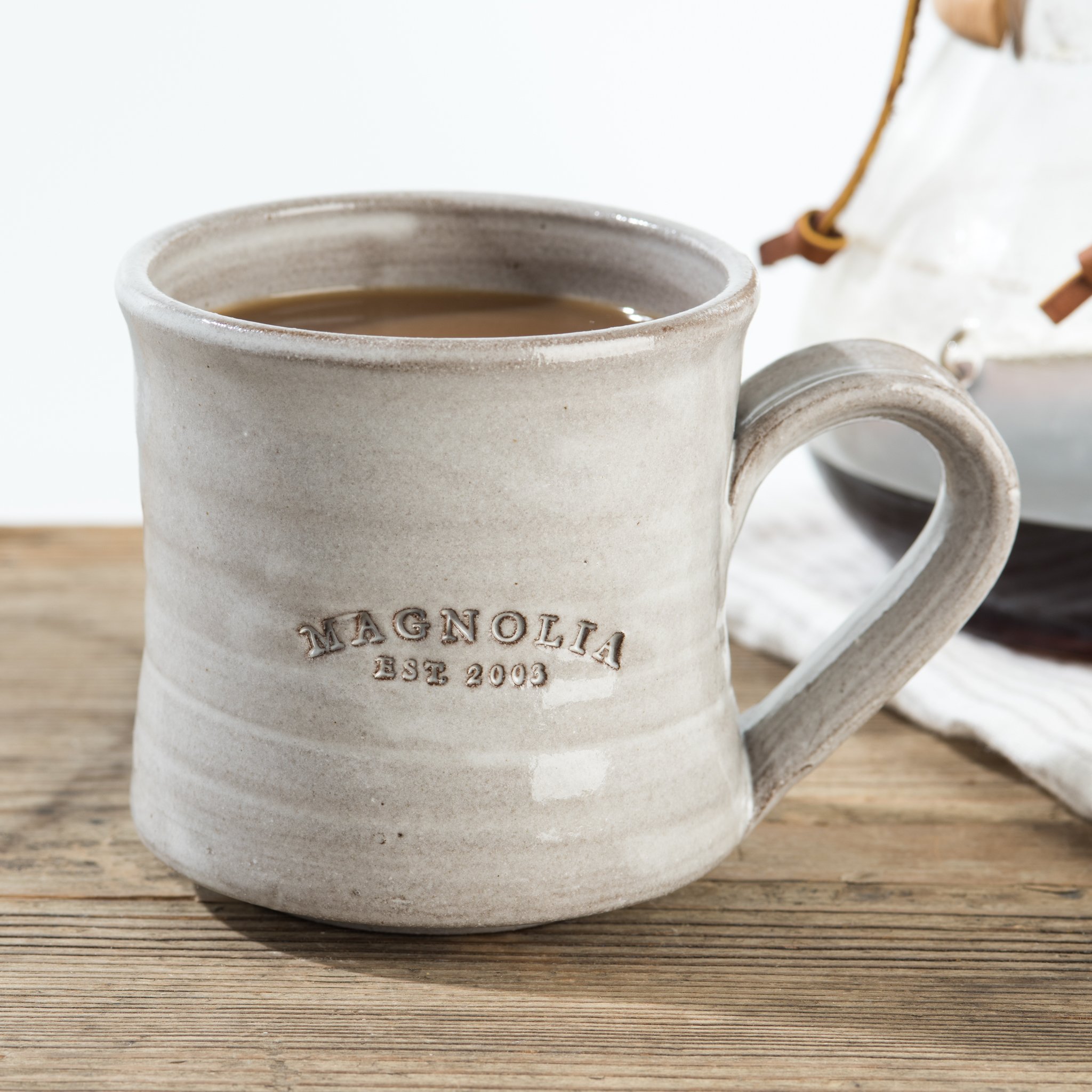 hand-thrown grey mug with magnolia established stamp  $24.00