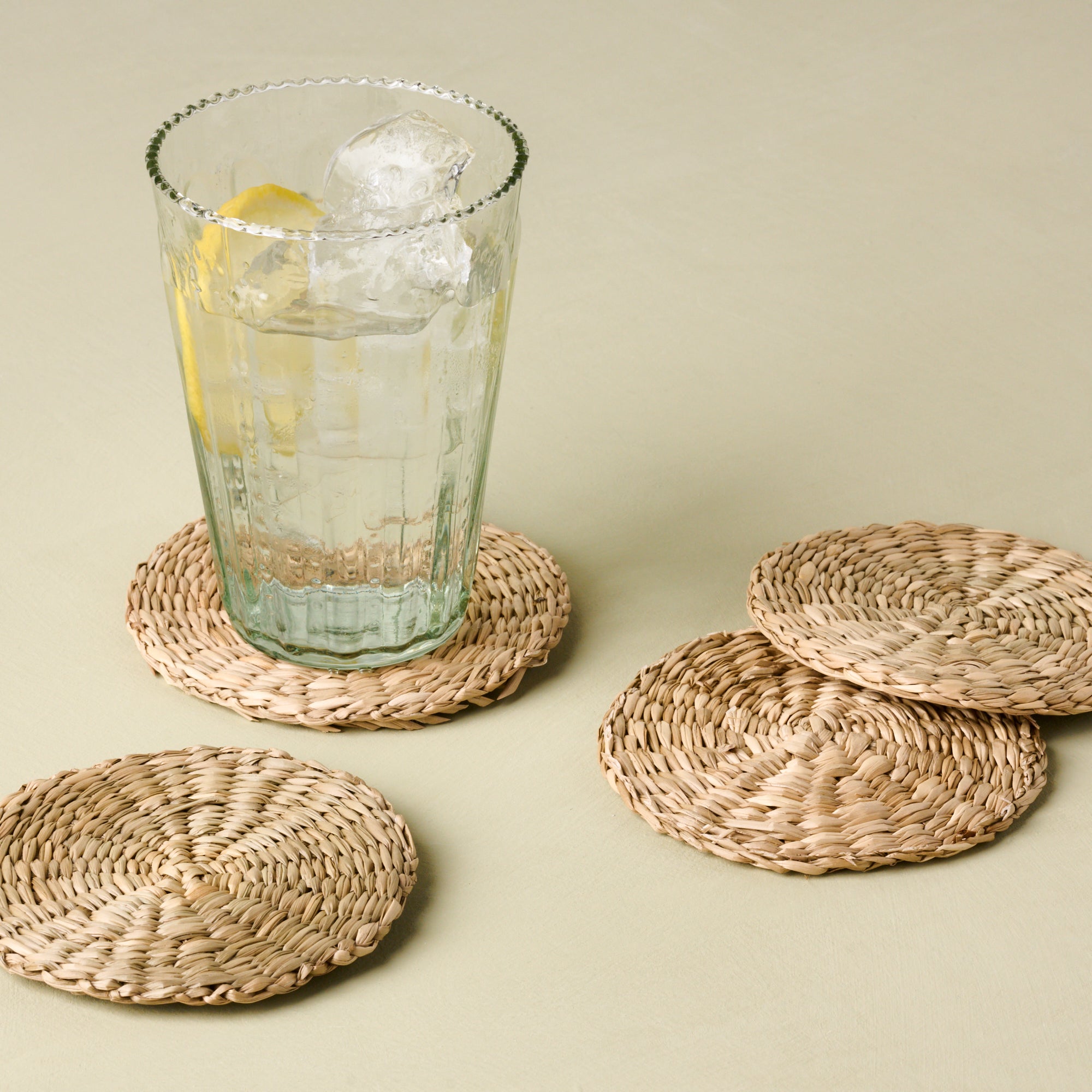 magnolia elizabeth bottle cut glass tumbler in tall size on wicker coaster Items range from $10.00 to $12.00